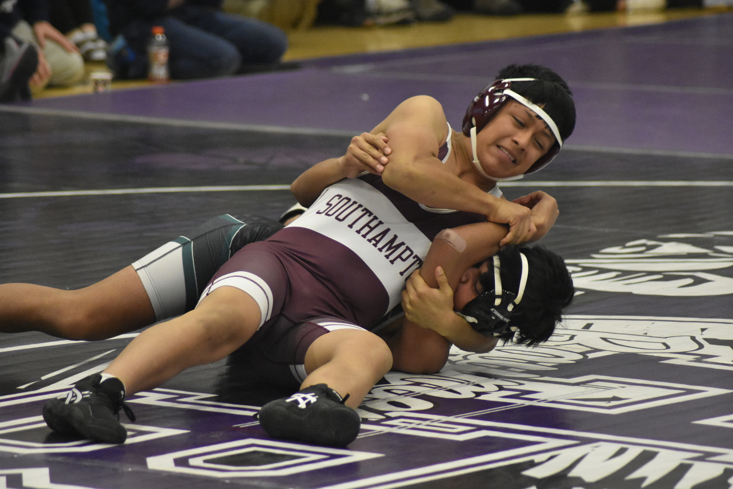 Fredy Chacon takes his Westhampton Beach opponent down to the mat in their JV match on Saturday.  DREW BUDD