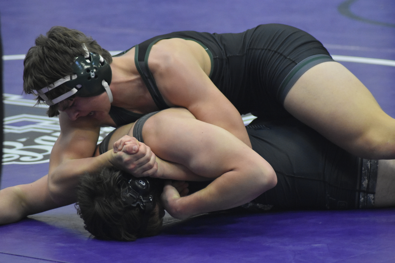 Westhampton Beach sophomore Andrew Lewis tries to turn over Ward Melville's Colin Spatz.   DREW BUDD