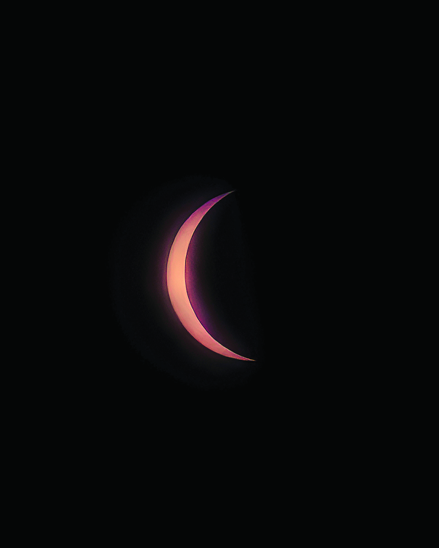 April 11 - A sliver of the sun pokes out from behind the moon at the peak of the eclipse on April 8. MARIANNE BARNETT