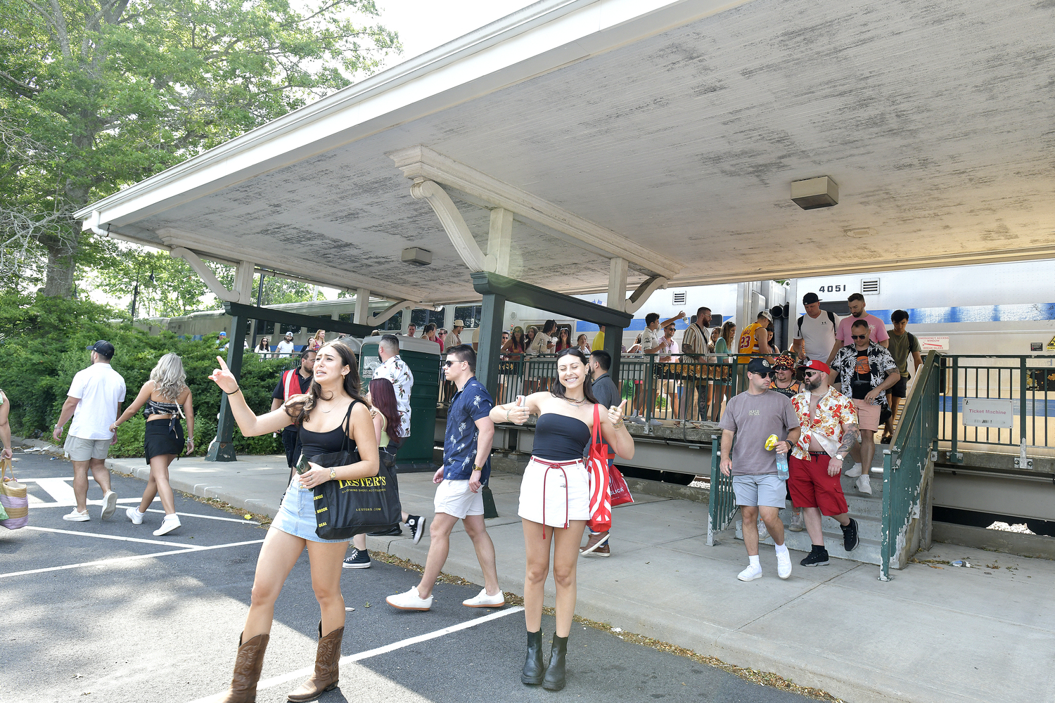 June 27 - Palm Tree Festival-goers arrive at the Southampton train station on June 22 to a line of shuttle buses to take them to the venue. DANA SHAW