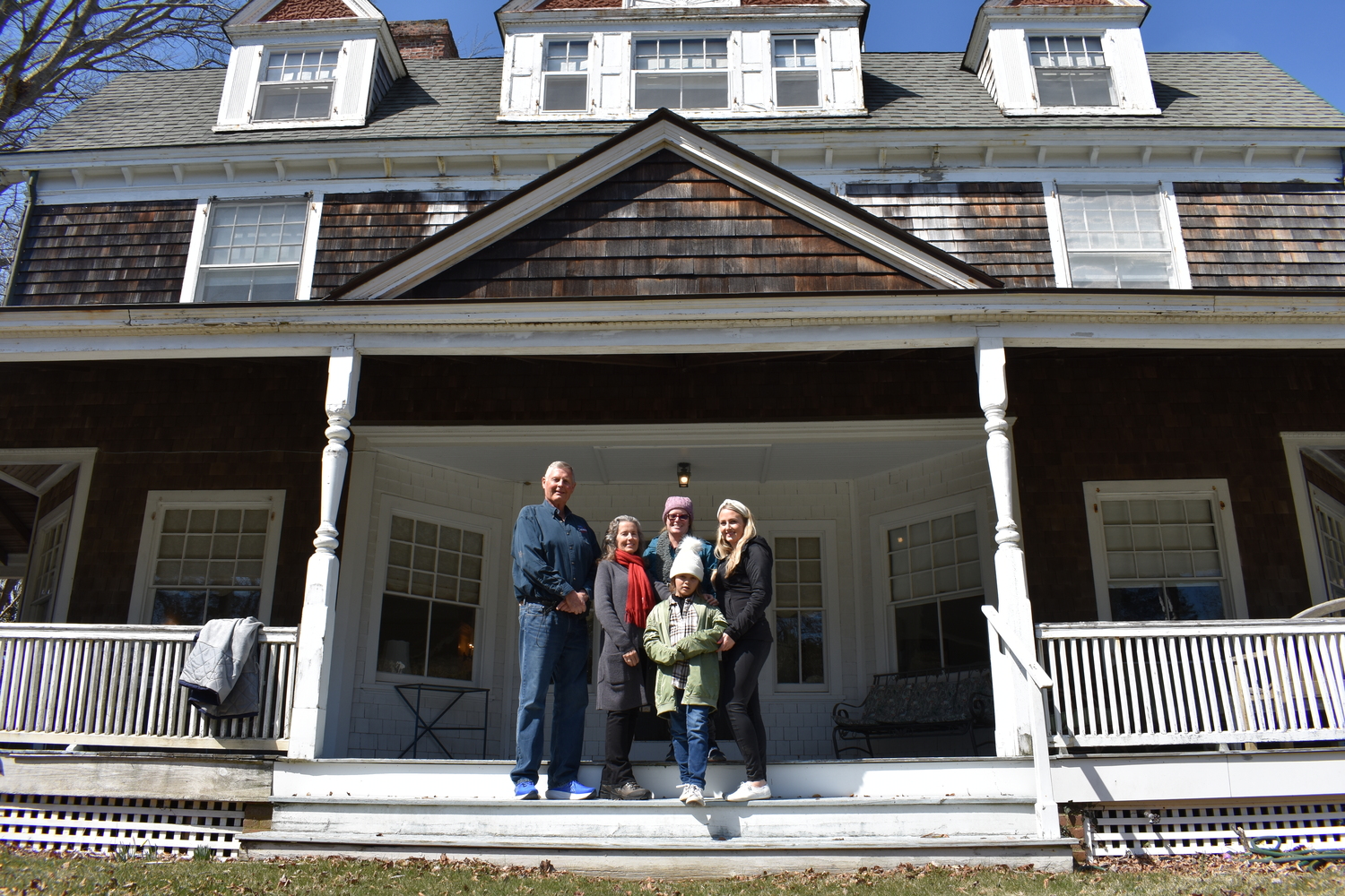 March 28 -- A Family Visit
L’Hommedieu descendants from California tour an East Hampton home by the 19th century architect
The 1892 Brooklyn Daily Eagle obituary for architect James H. L’Hommedieu referred to him as “one of the most prominent contractors and builders on Long Island,” responsible for “many fine residences” in Garden City and the Hamptons, but the extent of his contributions to Long Island’s built environment and his renown was unknown, until recently, to his descendants on the West Coast. That changed when L’Hommedieu’s great-great-granddaughter, Michele L’Hommedieu Hofmann, began researching her family tree. She planned a family trip to Long Island to see her ancestor’s work in Garden City. And when she learned that a house he built in East Hampton Village was currently on the market, she reached out to the listing agents, Liz Wohl and Jim MacMillan of Brown Harris Stevens, to inquire as to whether she’d be able to get a look inside the house. They were happy to oblige. Three generations of L’Hommedieu descendants toured the shingle-style, three-story house at 32 Ocean Avenue, a well-preserved example of his work that, according to historical preservationist Robert Hafner, was built in 1889 for Robert S. Bowne.  BRENDAN O'REILLY