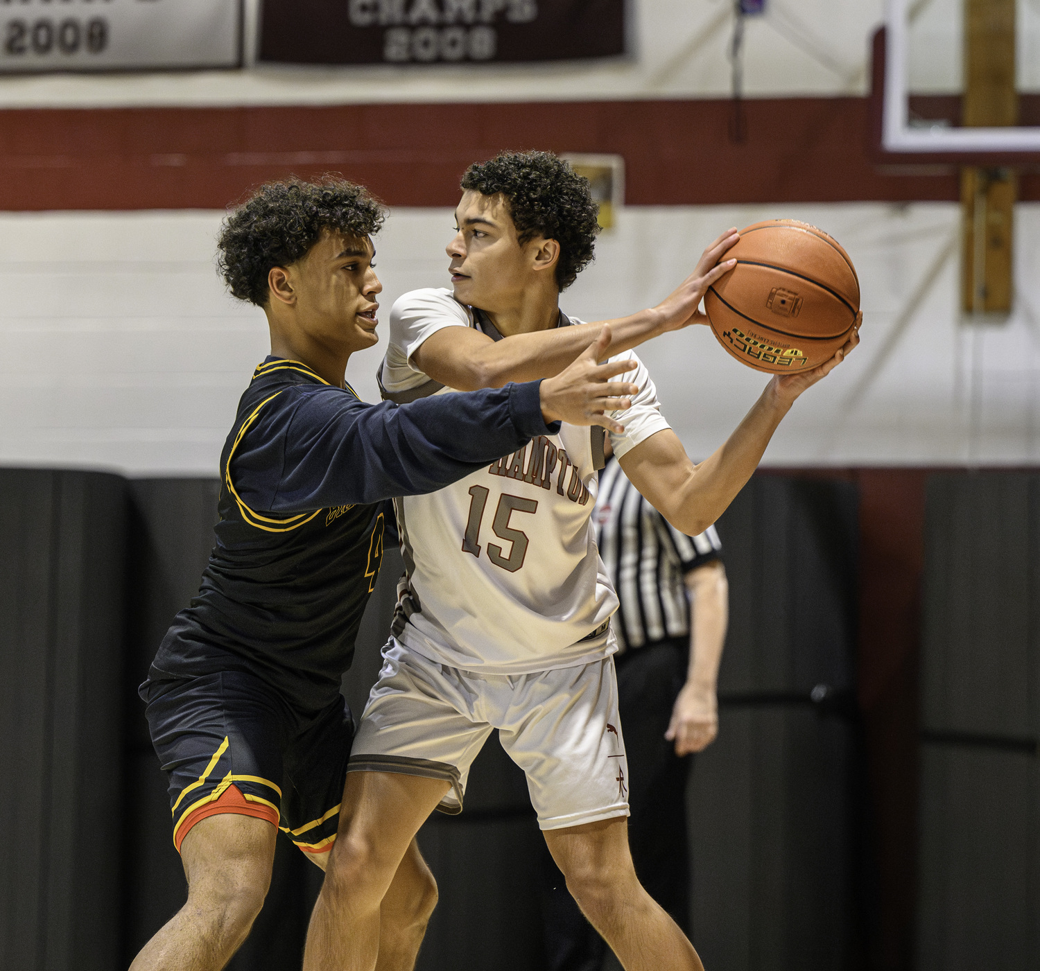 East Hampton's Aaron Brito looks to pass with Bridgehampton's Alex Davis pressuring him.   MARIANNE BARNETT