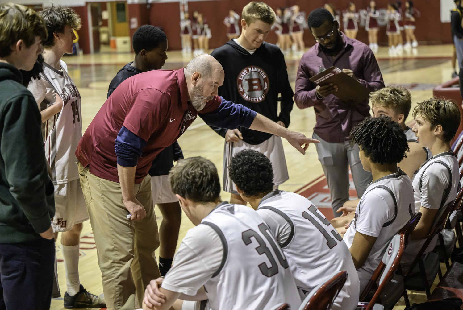 East Hampton head coach Dave Conlon talks to his team during a timeout.   MARIANNE BARNETT