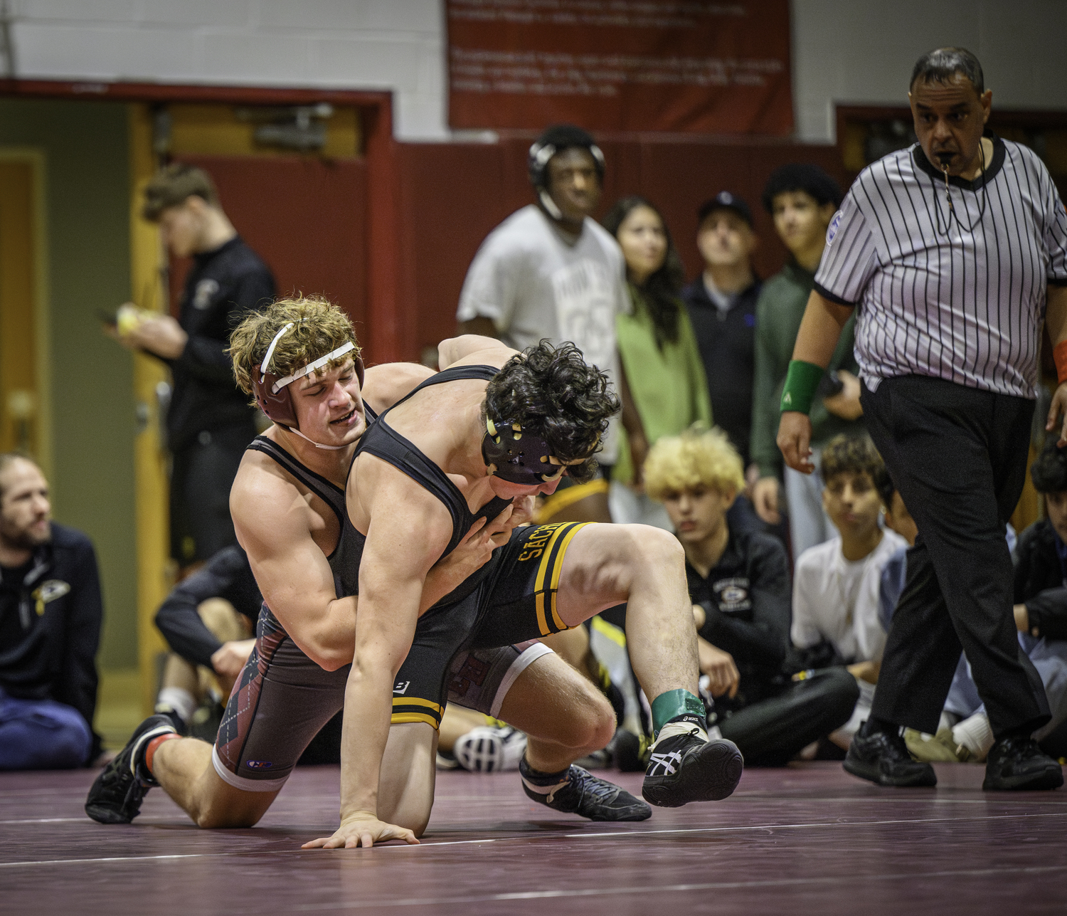 East Hampton senior Hudson Beckmann wrestles a Sachem North opponent. MARIANNE BARNETT