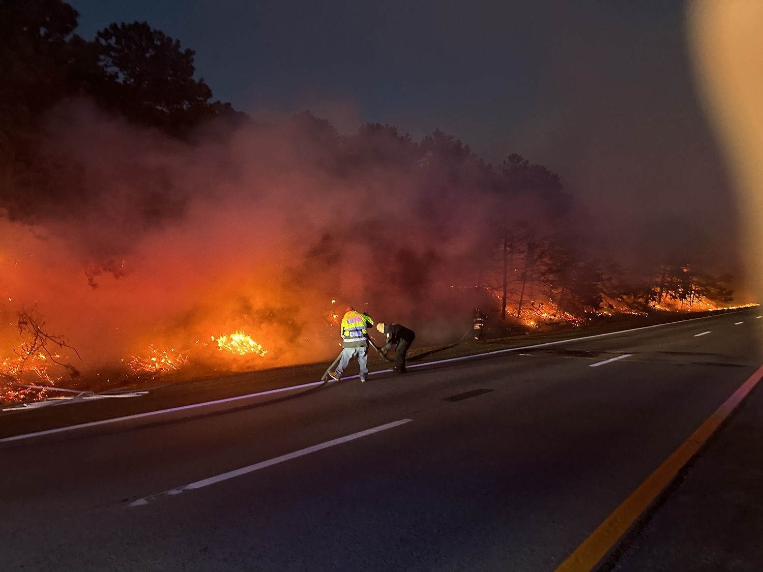 October 17 - Firefighters from the East Quogue Fire Department and the Hampton Bays Fire Department were able to snuff out a rapidly spreading brush fire that ignited along the side of Sunrise Highway during the Monday evening rush hour — in what a fire chief said could have been a much worse situation. The fire broke out Monday, October 14, between exits 65 and 66, where the highway runs through Sears Bellows County Park and the eastern reaches of the Pine Barrens — just a few miles east of where the infamous August 1995 Sunrise Wildfire scorched more than 5,500 acres of woodlands on either side of the highway.