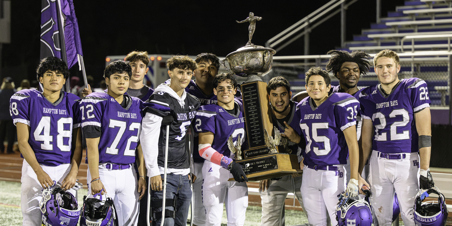 October 24 - Hampton Bays seniors with the Mayor's Cup after defeating rival Southampton, 39-14.  MARIANNE BARNETT