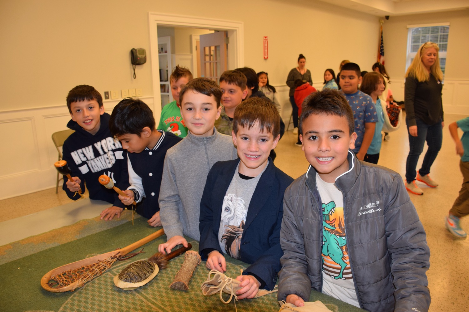 Hampton Bays Elementary School fourth graders recently learned more about the lives and history of Native Americans during a presentation by Journeys into American Indian Territory. Through the interactive workshop, students explored a Native American museum featuring artifacts such as clothing, dolls, pottery and a longhouse replica. They also listened to traditional Native American stories. COURTESY HAMPTON BAYS SCHOOL DISTRICT