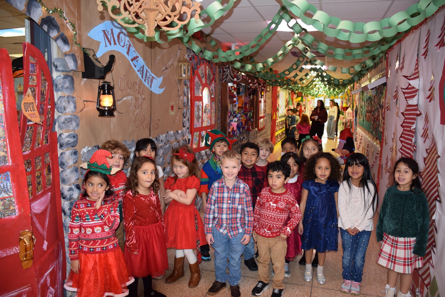 The kindergarten hallway at Hampton Bays Elementary School has been transformed into a holiday wonderland with a theme of Downtown Disney. Teachers and their students worked to bring the vision to life over the past several weeks. Each class created elaborate displays outside their classroom that depict shops from Downtown Disney. There is a Starbucks, Mini Mouse bake shop, Pineapple Dole Whip shop, art and clock stores among others. Students dressed in their holiday best on December 11 to celebrate the completion of the hallway. COURTESY HAMPTON BAYS SCHOOL DISTRICT