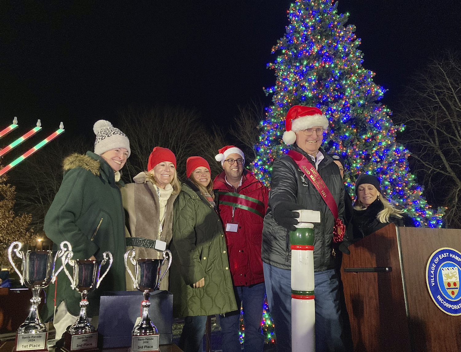 John Ryan Sr., Grandfather Marshal of the Santa Parade, lights the tree in Herrick Park on Saturday evening.  KYRIL BROMLEY