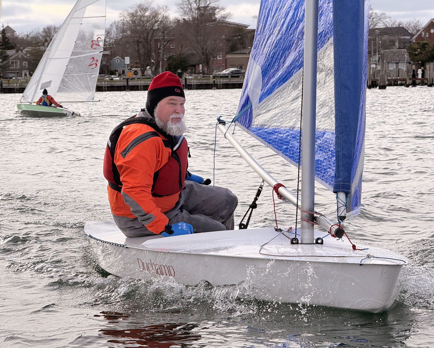 Marty Knab, who assisted the photographer in setting up the four course buoys before being dropped off dockside to race, on an opposite tack with Gloria Frazee.   MICHAEL MELLA