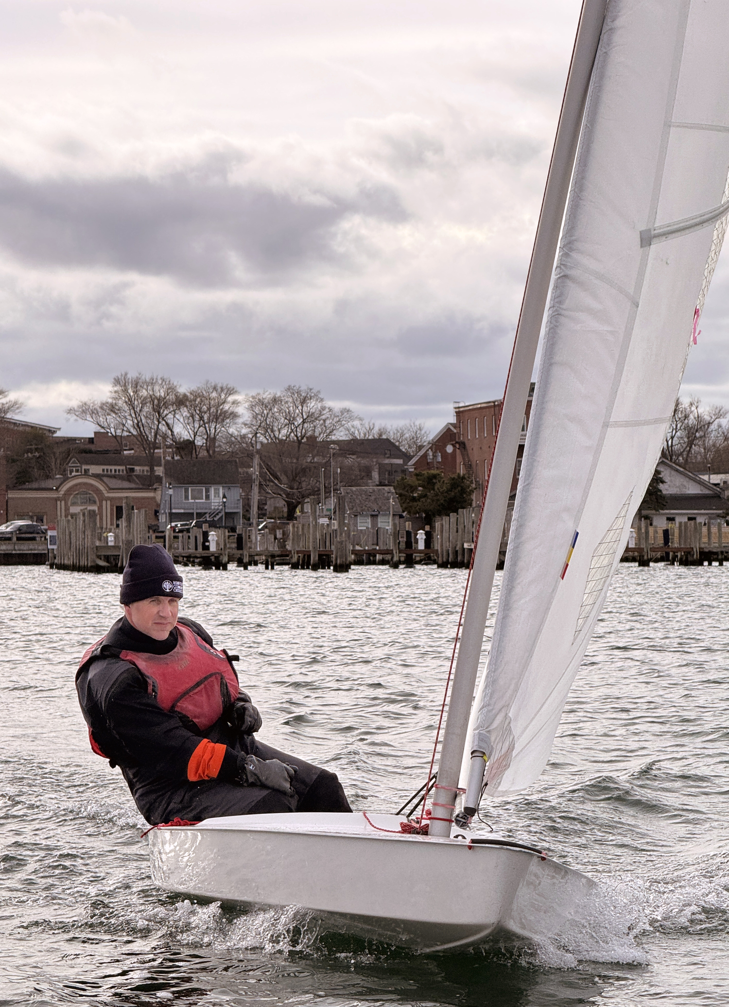 Commodore Nick Gazzolo exhibiting laser beam focus on sail trim as he ducks the photographer’s race committee boat and scores a win.  MICHAEL MELLA