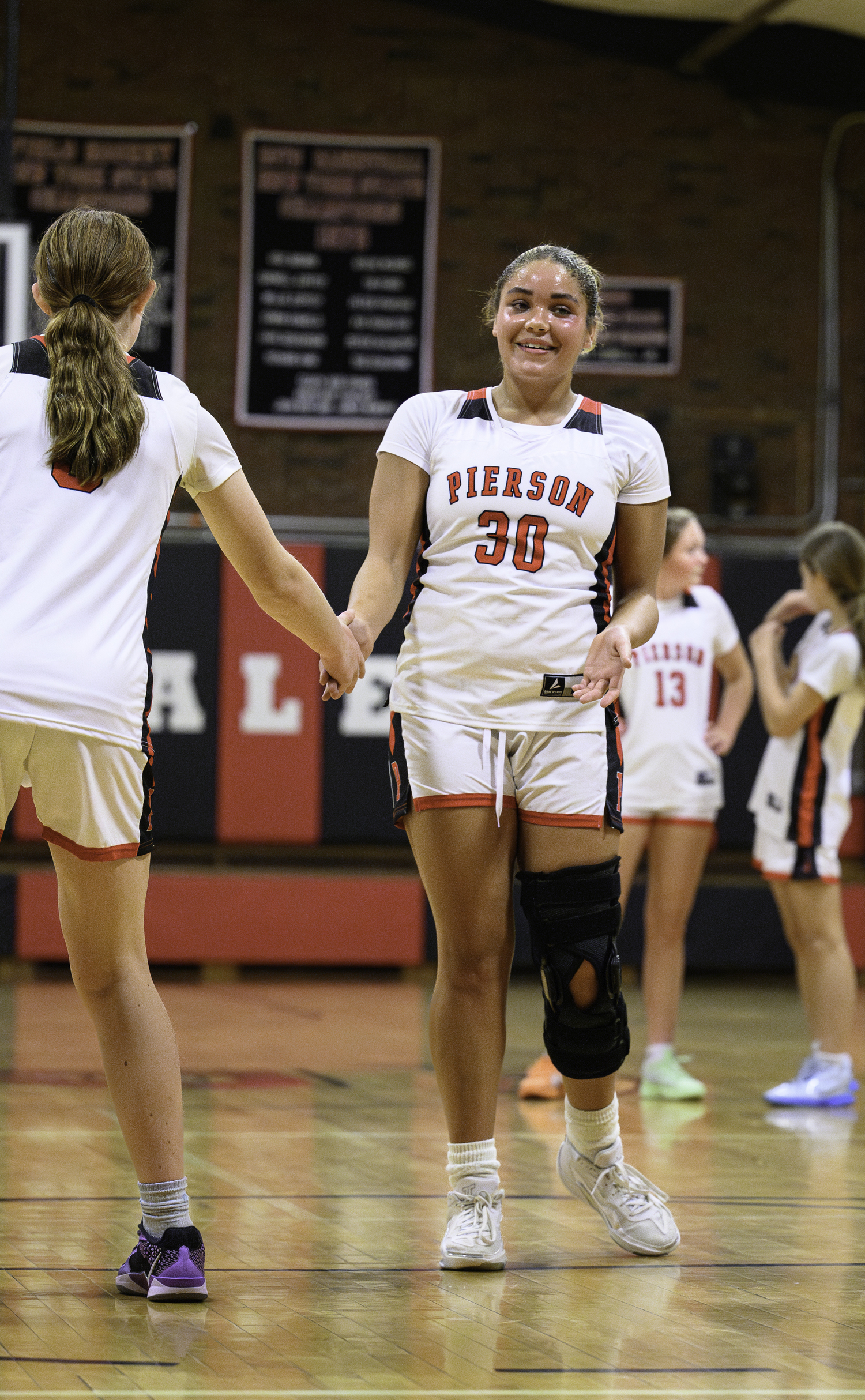 Ani Bedini is congratulated after making a free throw.   MARIANNE BARNETT