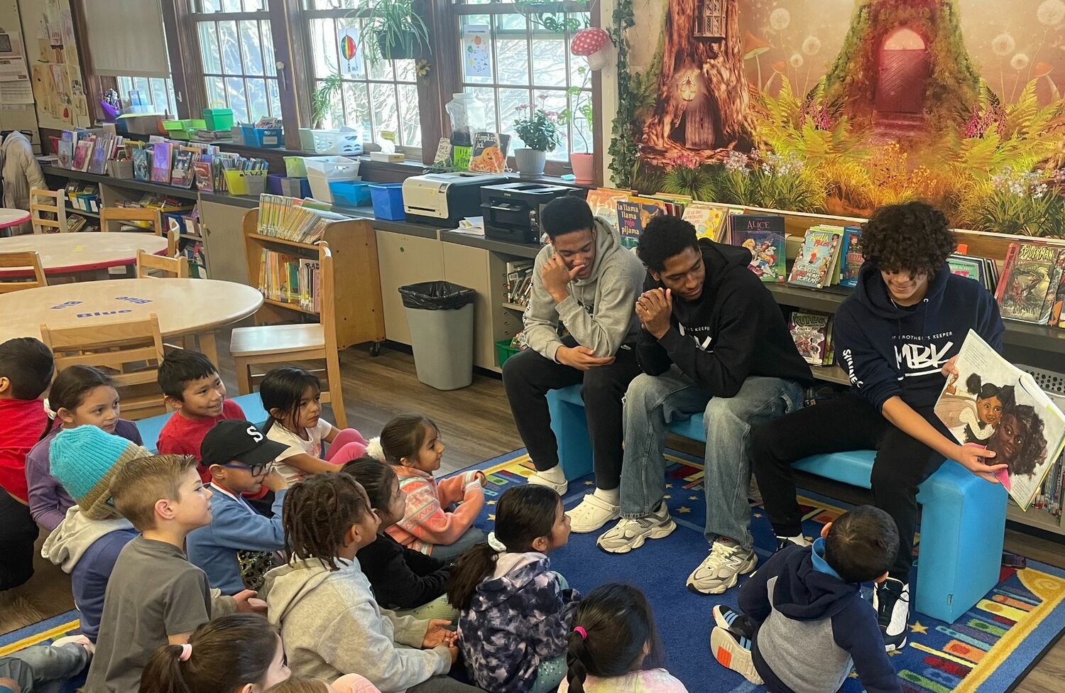 To celebrate Black History Month, members of My Brother's Keeper, from left, Davon Palmore, Tyrese Reddick and Sean Smith, visit Southampton Elementary School as guest readers. COURTESY SHAWN SMITH