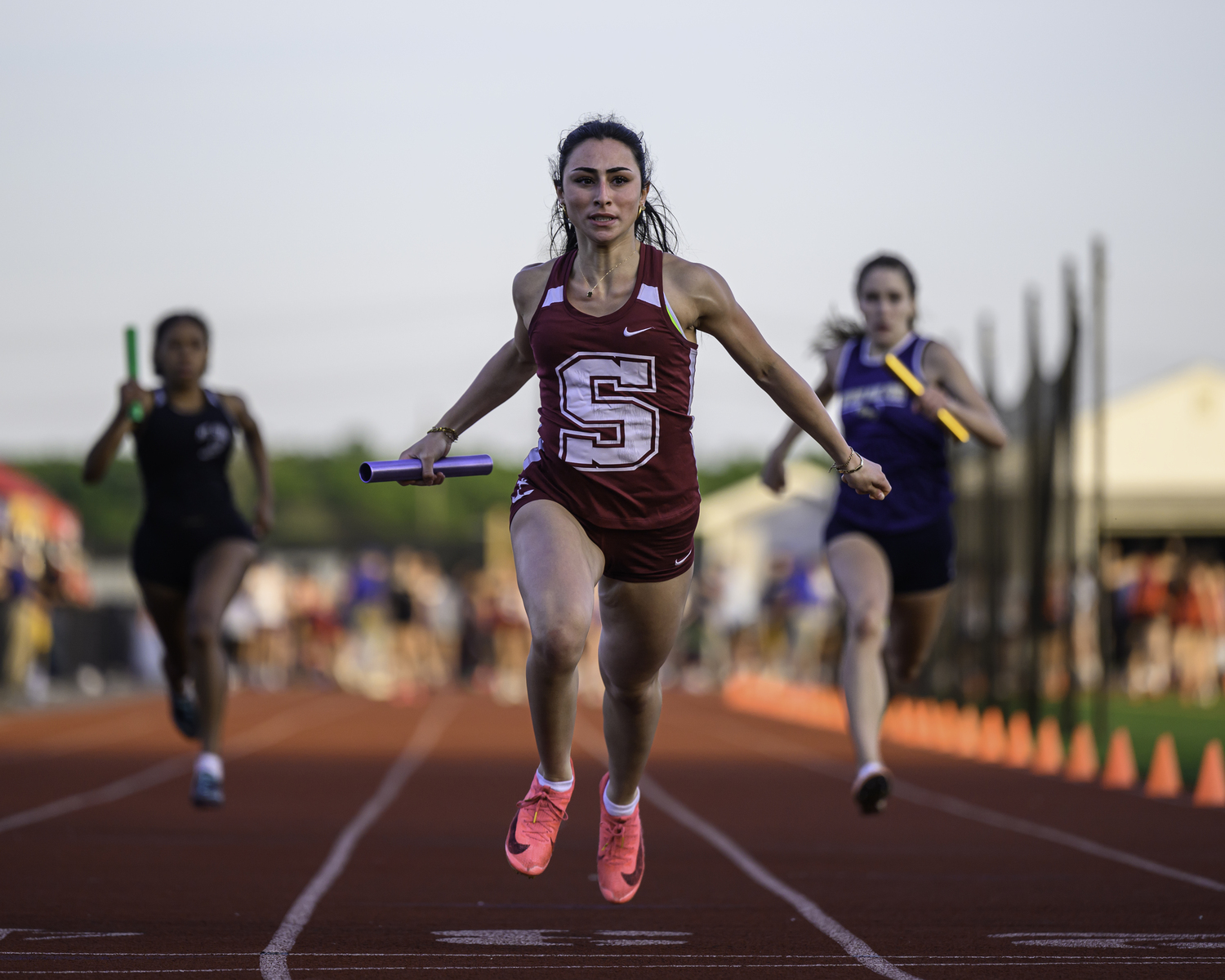 May 30 - Kyla Cerullo crosses the finish line in first place to help the Southampton girls 4x100-meter relay team win the county title.  MARIANNE BARNETT