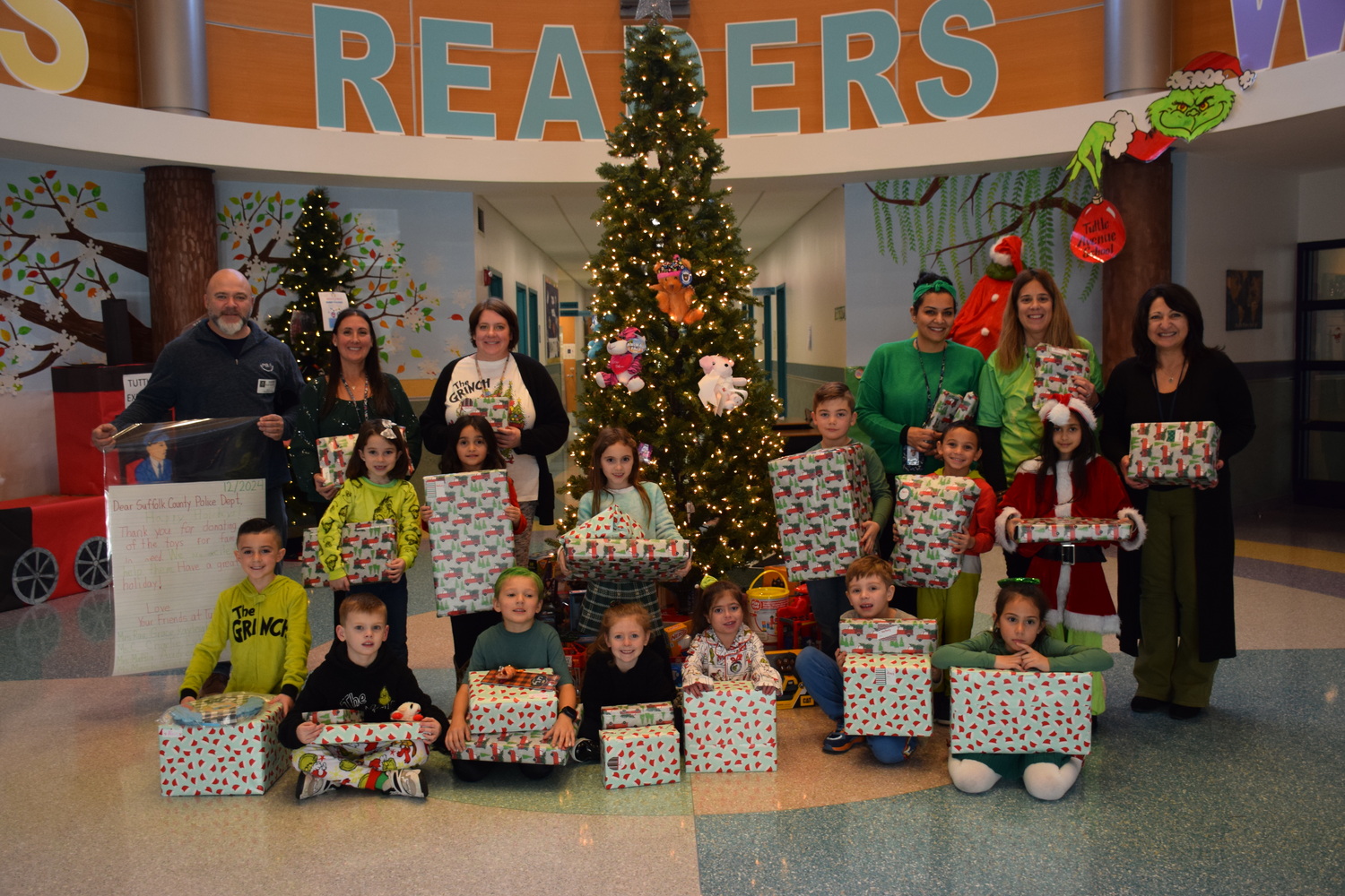 Tuttle Avenue Elementary School students from Nicole Rau’s and Lisa Maffia’s class donated
toys and gifts to families in the community with the help of, left, the Suffolk County Police
Conference and its president David Samartino. COURTESY EASTPORT-SOUTH MANOR SCHOOL DISTRICT