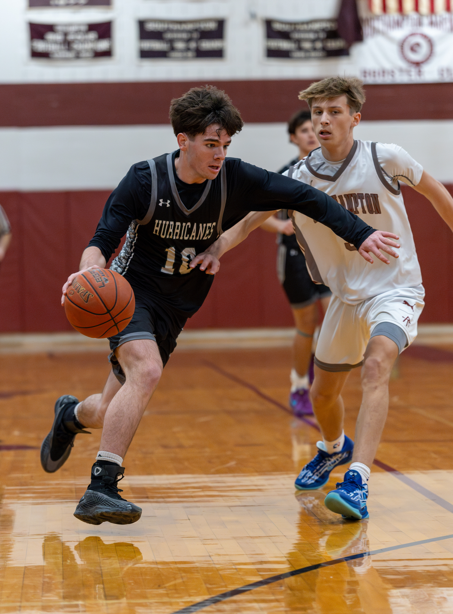 Westhampton Beach junior Truman Hahn speeds by East Hampton junior Toby Foster.   RON ESPOSITO