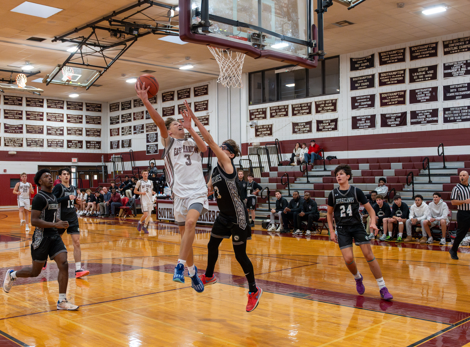 East Hampton junior Toby Foster takes some contact from Westhampton Beach sophomore Sam Quinn while going up with the ball.   RON ESPOSITO