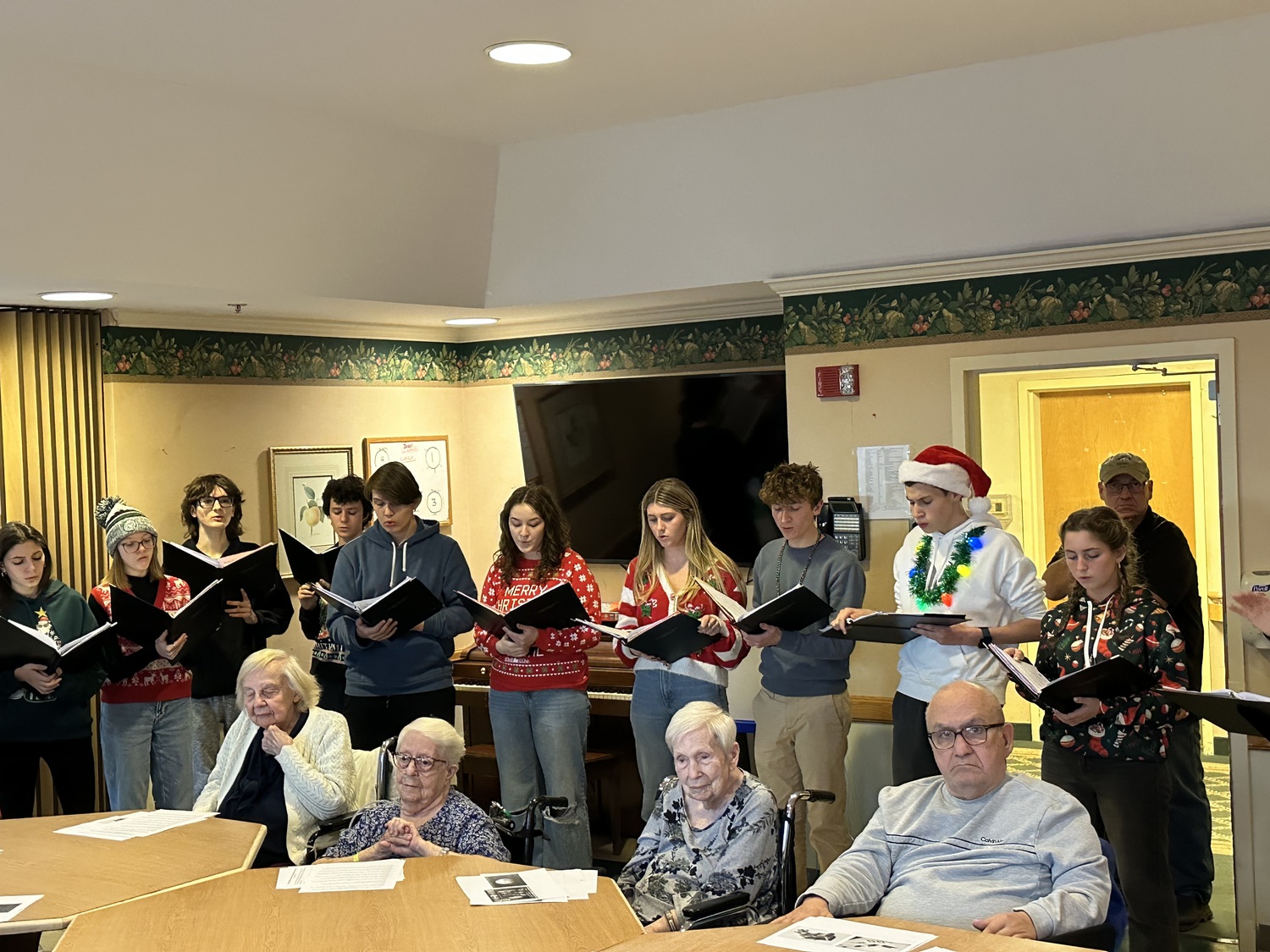 Westhampton Beach High School chamber singers brought holiday cheer to the residents of the Westhampton Care Center on December 12. During their visit, the singers performed their concert repertoire and delivered handmade holiday cards to the residents. COURTESY WESTHAMPTON BEACH SCHOOL DISTRICT