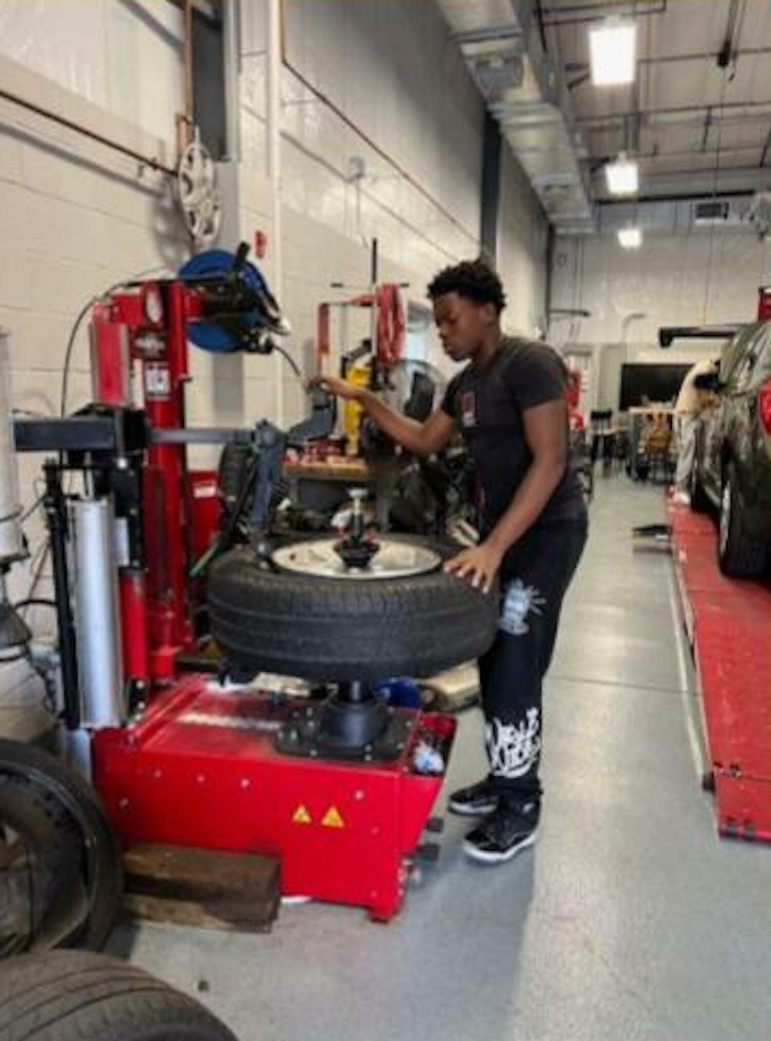 Senior Josh Williams works on a tire. EAST HAMPTON SCHOOL DISTRICT