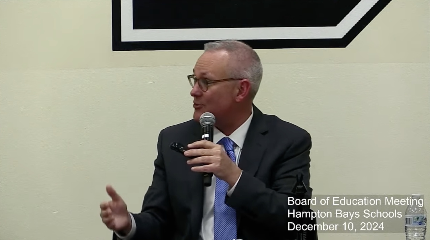 Hampton Bays Superintendent Lars Clemensen reveals Handle With Care, the district's partnership with the Southampton Town Police Department, during the December 10 board of education meeting.