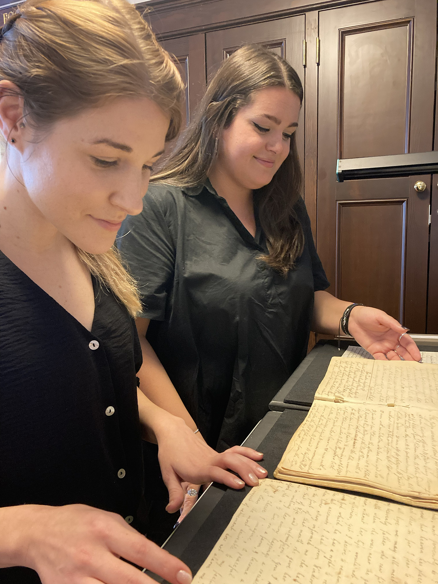 Adelaide Webb, Long Island Collection scanning assistant, and Megan Bardis, Long Island Collection librarian/archivist, scan documents from Preservation Long Island. KERI LAMPARTER