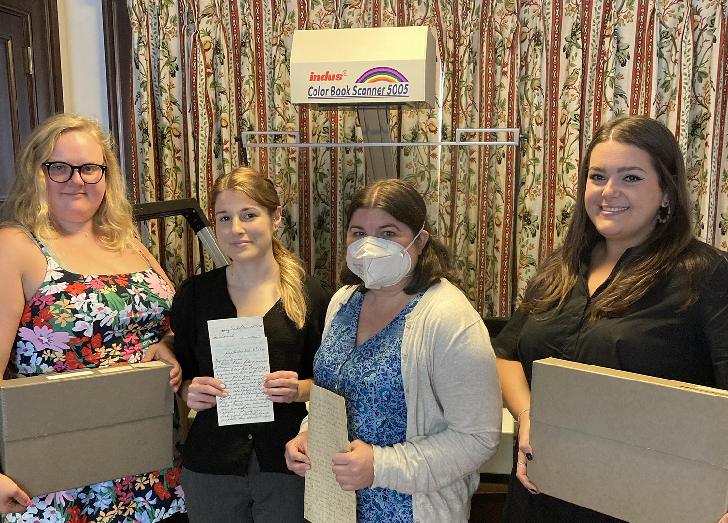 Julia Tyson, Long Island Collection librarian/archivist), Adelaide Webb, Long Island Collection scanning assistant, Andrea Meyer, librarian/archivist and head of the Long Island Collection and Megan Bardis, Long Island Collection librarian/archivist. KERI LAMPARTER