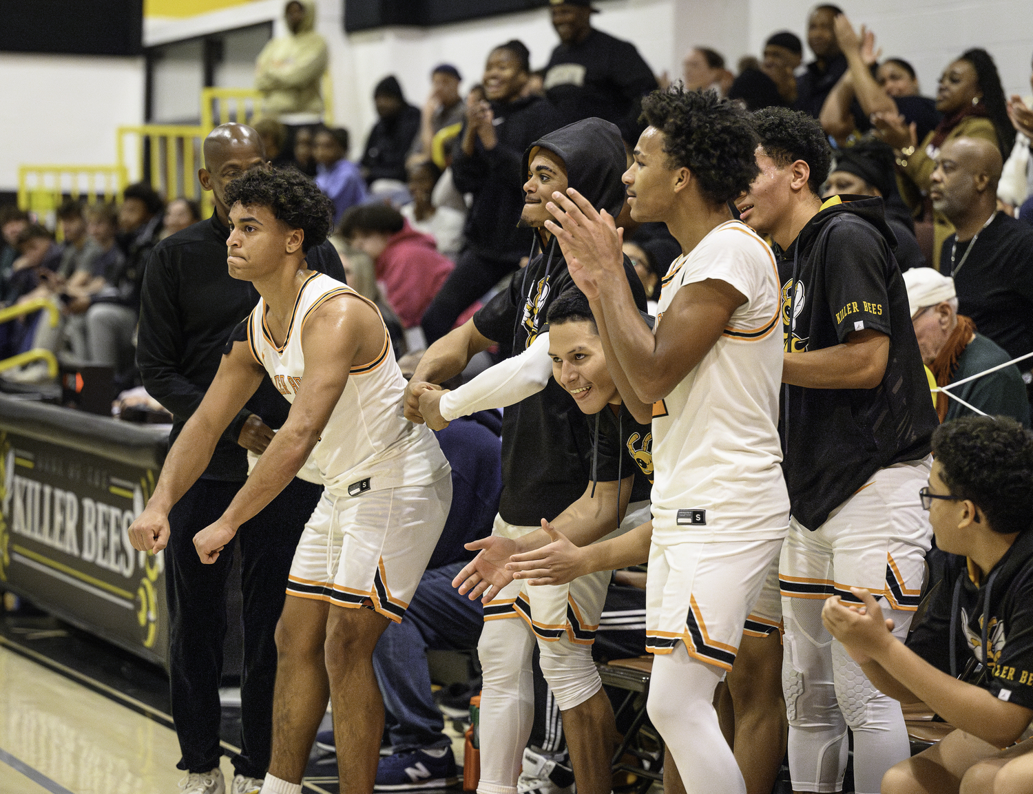 Many of the Bees starters, on the bench in the fourth quarter with a big lead, cheer on their teammates who continue to pour it on Greenport.   MARIANNE BARNETT