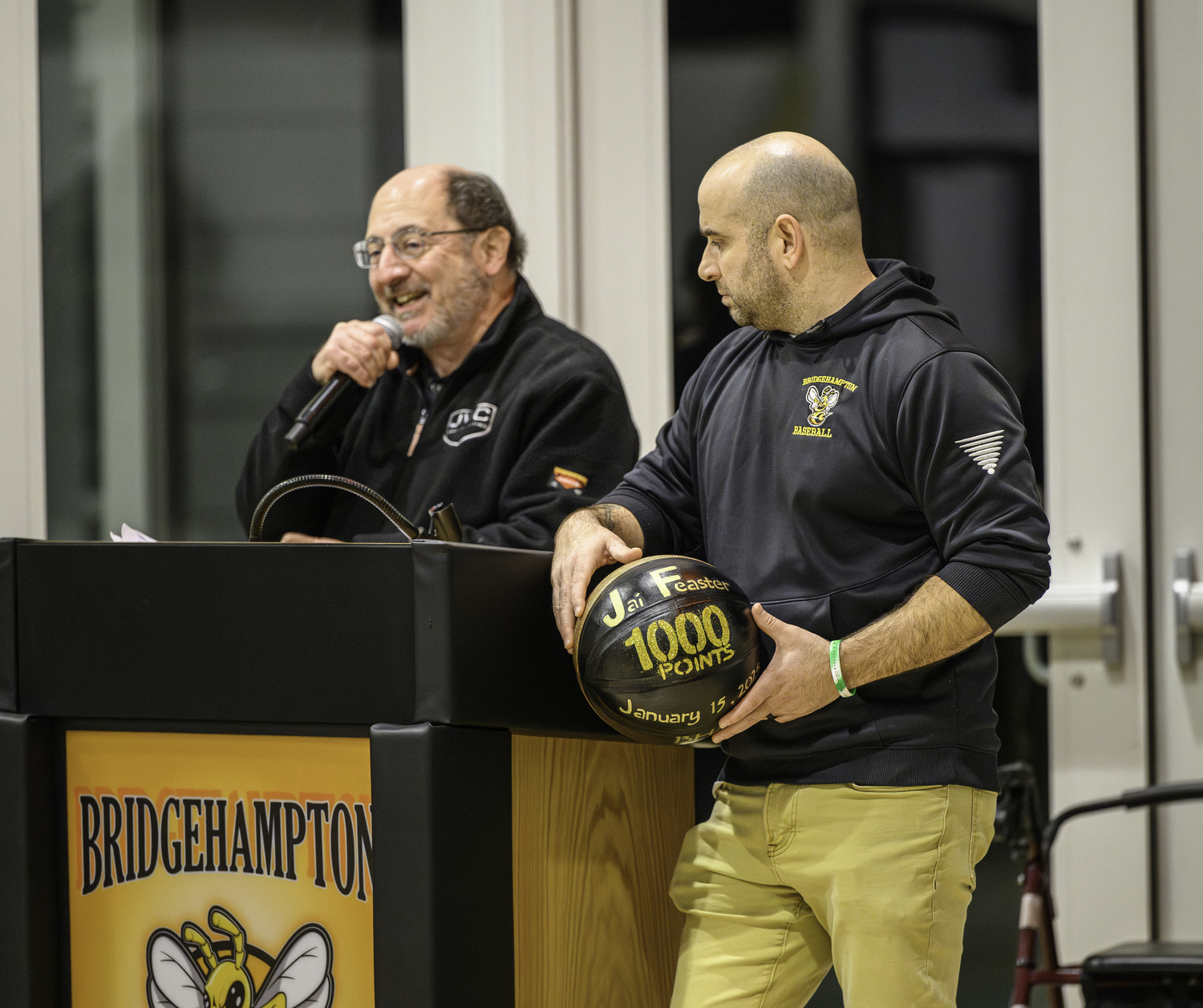 Announcer John Marino, left, and Bridgehampton Athletic Director Michael DeRosa, announce Jai Feaster's career milestone of 1,000 career points prior to Friday night's home game against Greenport.   MARIANNE BARNETT