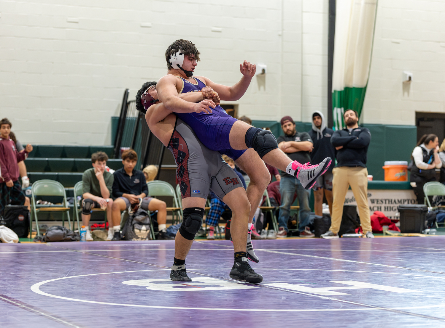 East Hampton's Juan Espinoza lifts an opponent at the Cory Hubbard Duals. RON ESPOSITO