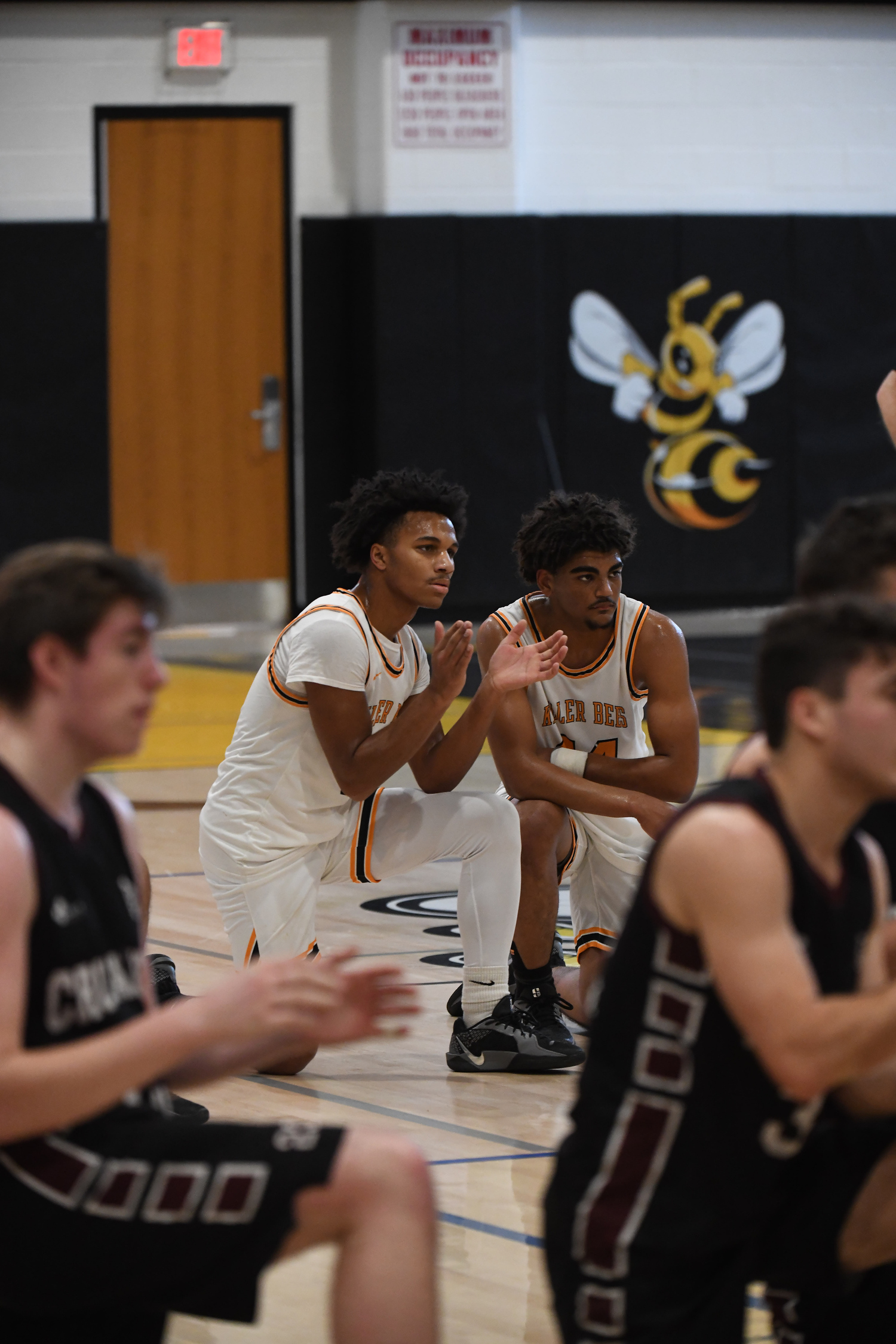 Jai Feaster, left, and Jordan Harding look on as teammate Xavier Johnson is being attended to.   DOUG KUNTZ