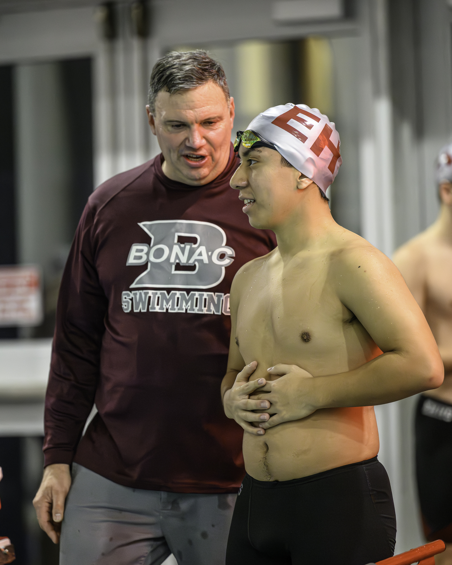 East Hampton senior Cristian Sigua talks with coach Brian Cunningham. MARIANNE BARNETT