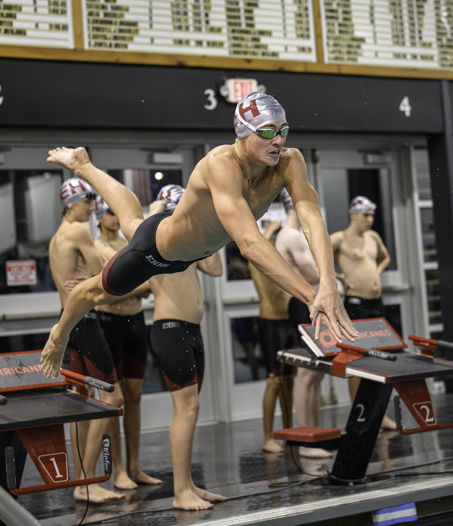 East Hampton junior Liam Knight dives into the pool. MARIANNE BARNETT