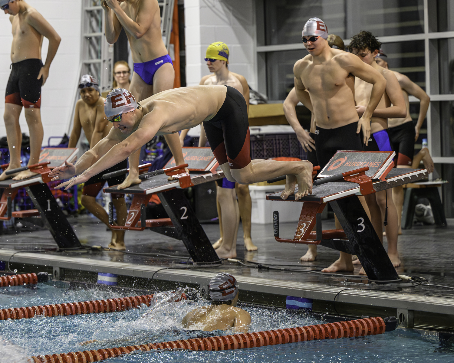 East Hampton junior Zeb Ryan dives into the water after Pierson sophomore Nick Chavez completes his leg and Pierson junior Dylan Knapik waits his turn as part of the 200-yard freestyle relay, which placed second. MARIANNE BARNETT