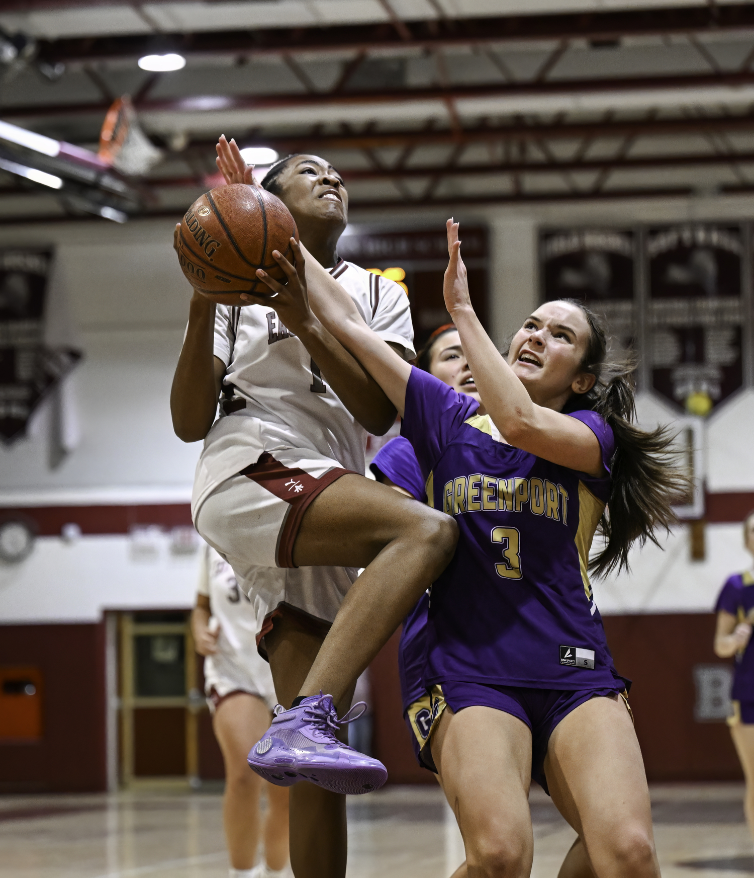 Bonacker K.K. Moore goes up for a basket against Greenport/Southold's Abbigail Bednoski.   MARIANNE BARNETT