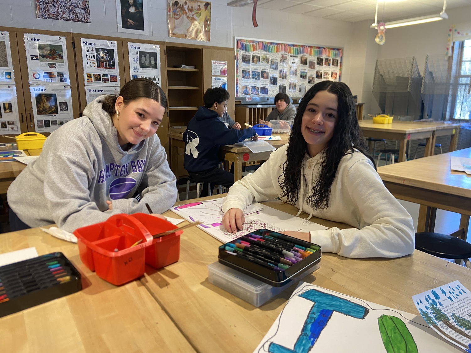 Hampton Bays Middle School seventh and eighth grade students, including Louise Brumagim and Angela Lombardi recently explored the power of blackout poetry, a
creative process where they “black out” words from a page of text to reveal their own
poem. After crafting their poems, the students illustrated them with various media, including watercolors, markers and colored pencil. COURTESY HAMPTON BAYS MIDDLE SCHOOL