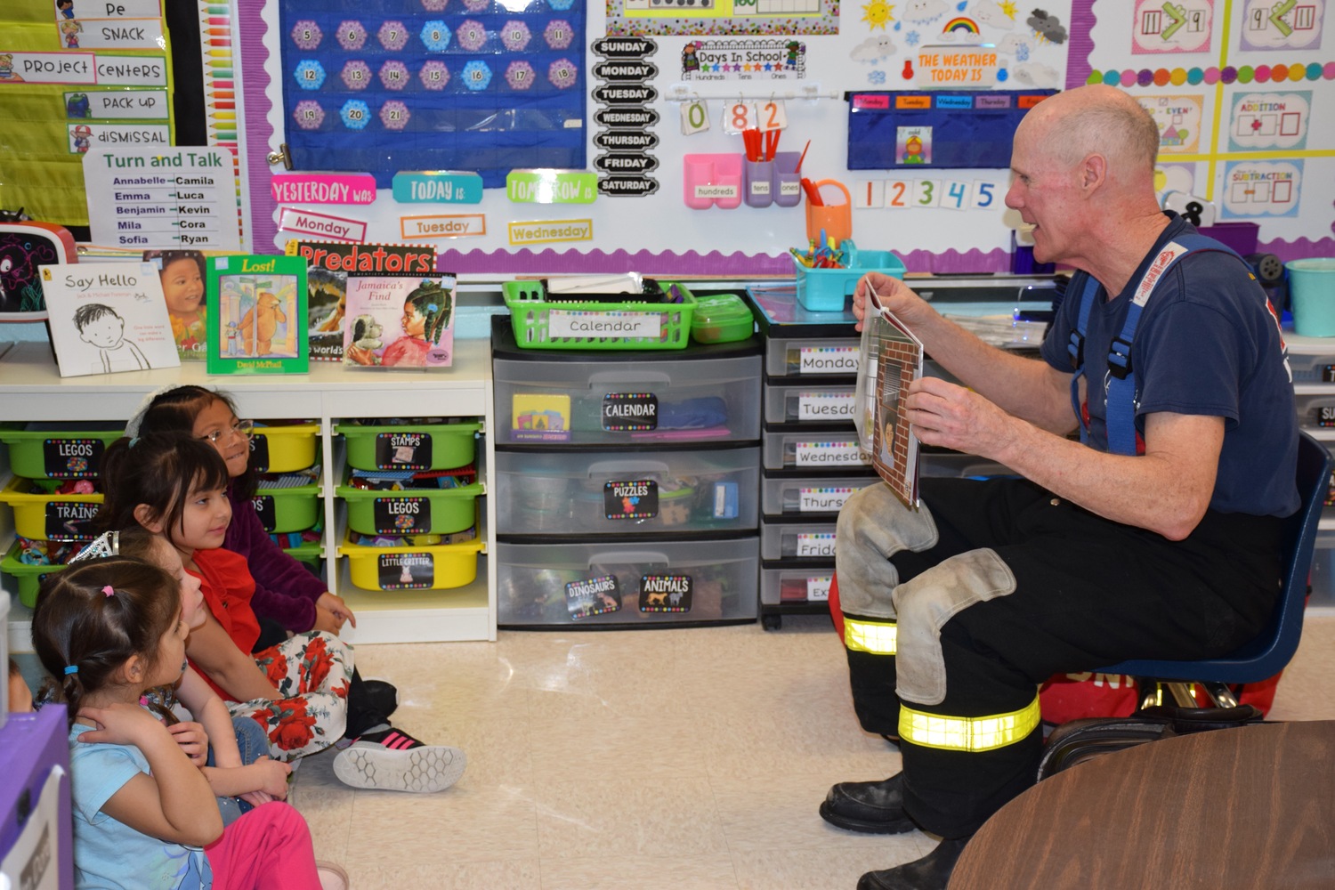 Hampton Bays Elementary School kindergartners recently enjoyed a visit
from children’s author and retired New York City firefighter Tim Hoppey. Dressed in his firefighter gear, Hoppey read two of his popular books, “Tito, the Firefighter” and “The Good Fire Helmet,” to the students. Following the reading, the students asked the author questions about his life as a firefighter and his writing. COURTESY HAMPTON BAYS SCHOOL DISTRICT