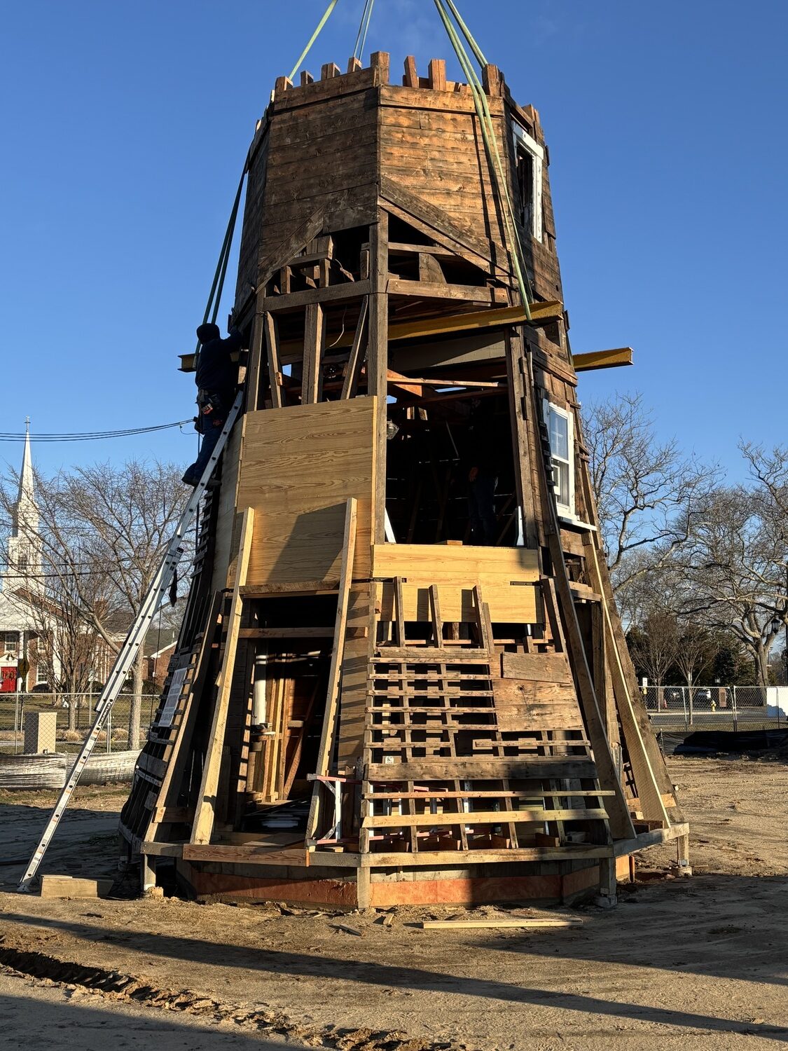 The top two portions of the Dix Windmill were placed on top of the windmill last Thursday, January 2, on the Great Lawn in Westhampton Beach. COURTESY MATT JEDLICKA, LKMA