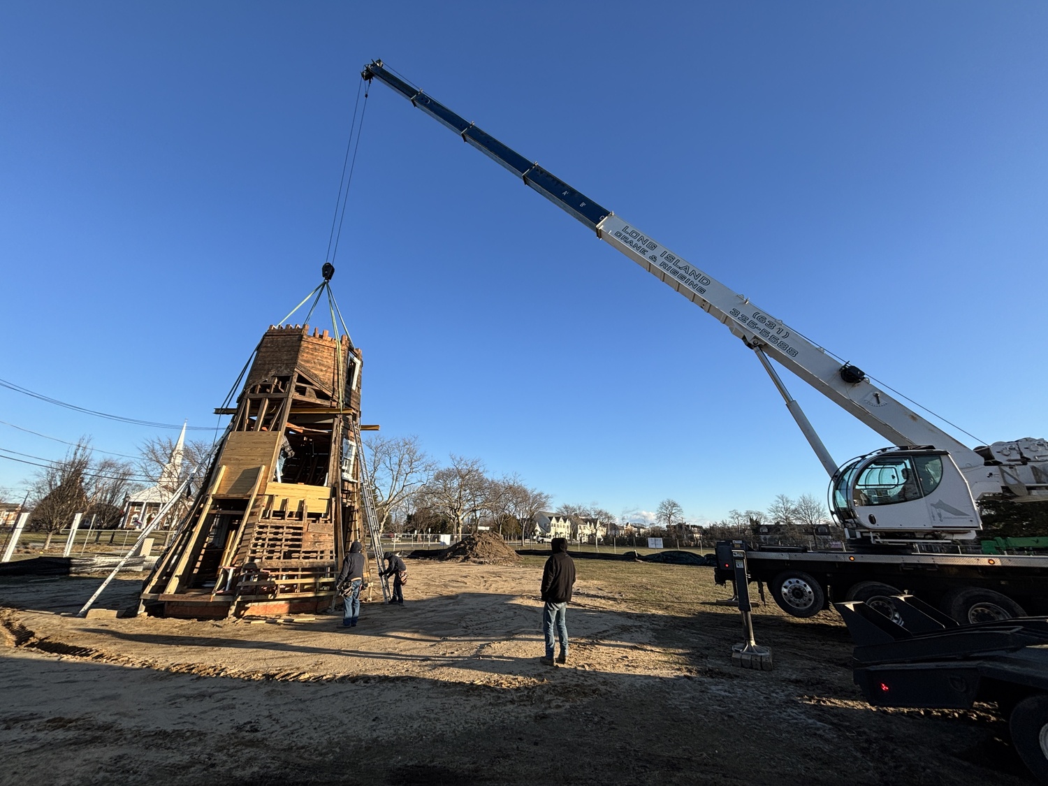 The top two portions of the Dix Windmill were placed on top of the windmill last Thursday, January 2, on the Great Lawn in Westhampton Beach. COURTESY MATT JEDLICKA, LKMA