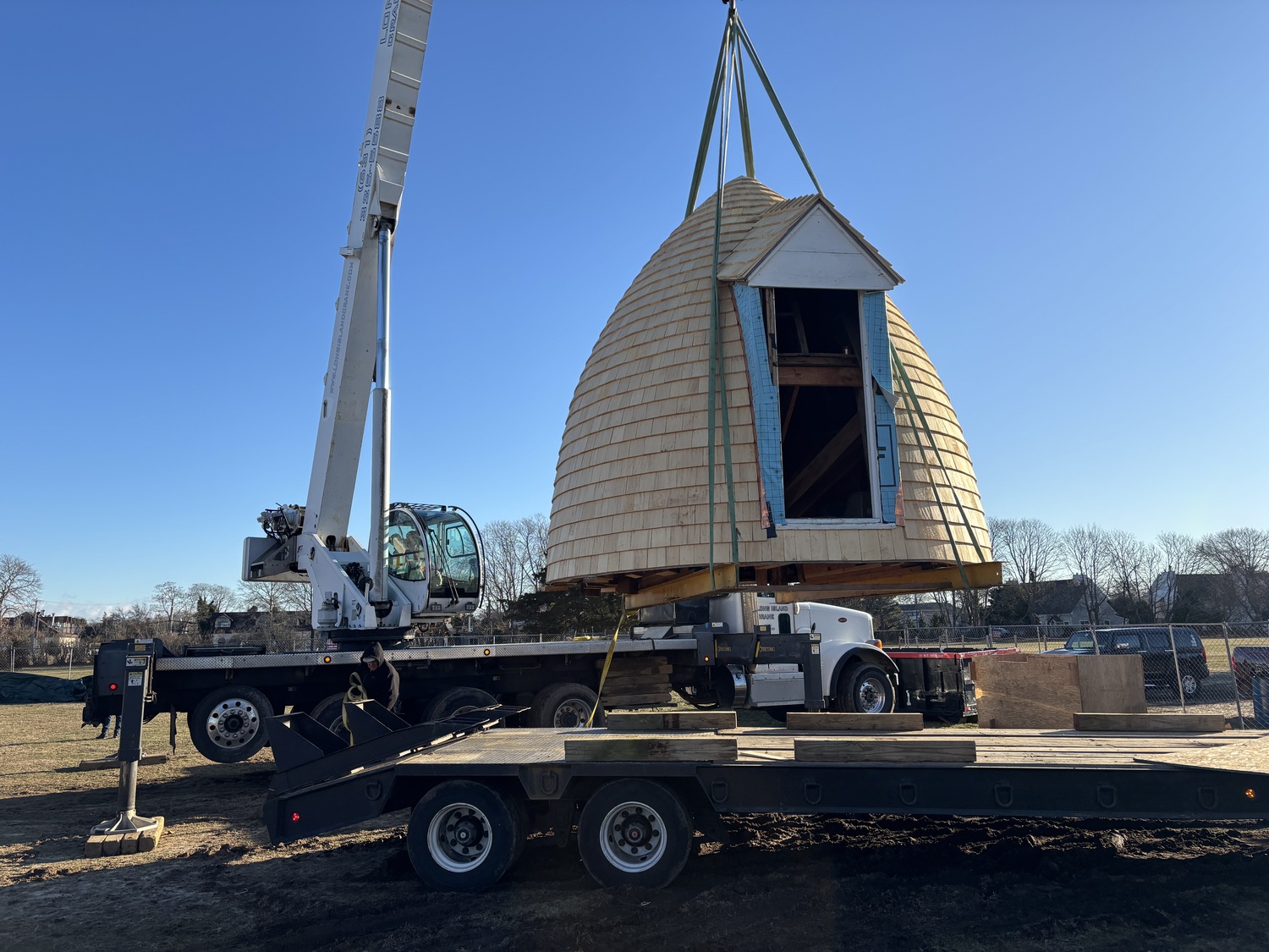 The top two portions of the Dix Windmill were placed on top of the windmill last Thursday, January 2, on the Great Lawn in Westhampton Beach. COURTESY MATT JEDLICKA, LKMA