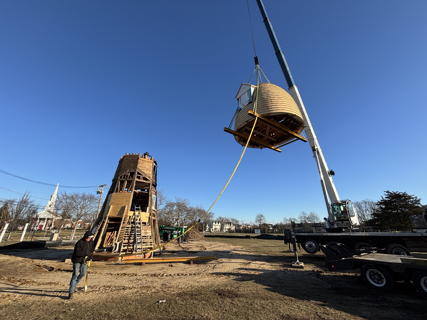 The top two portions of the Dix Windmill were placed on top of the windmill last Thursday, January 2, on the Great Lawn in Westhampton Beach. COURTESY MATT JEDLICKA, LKMA