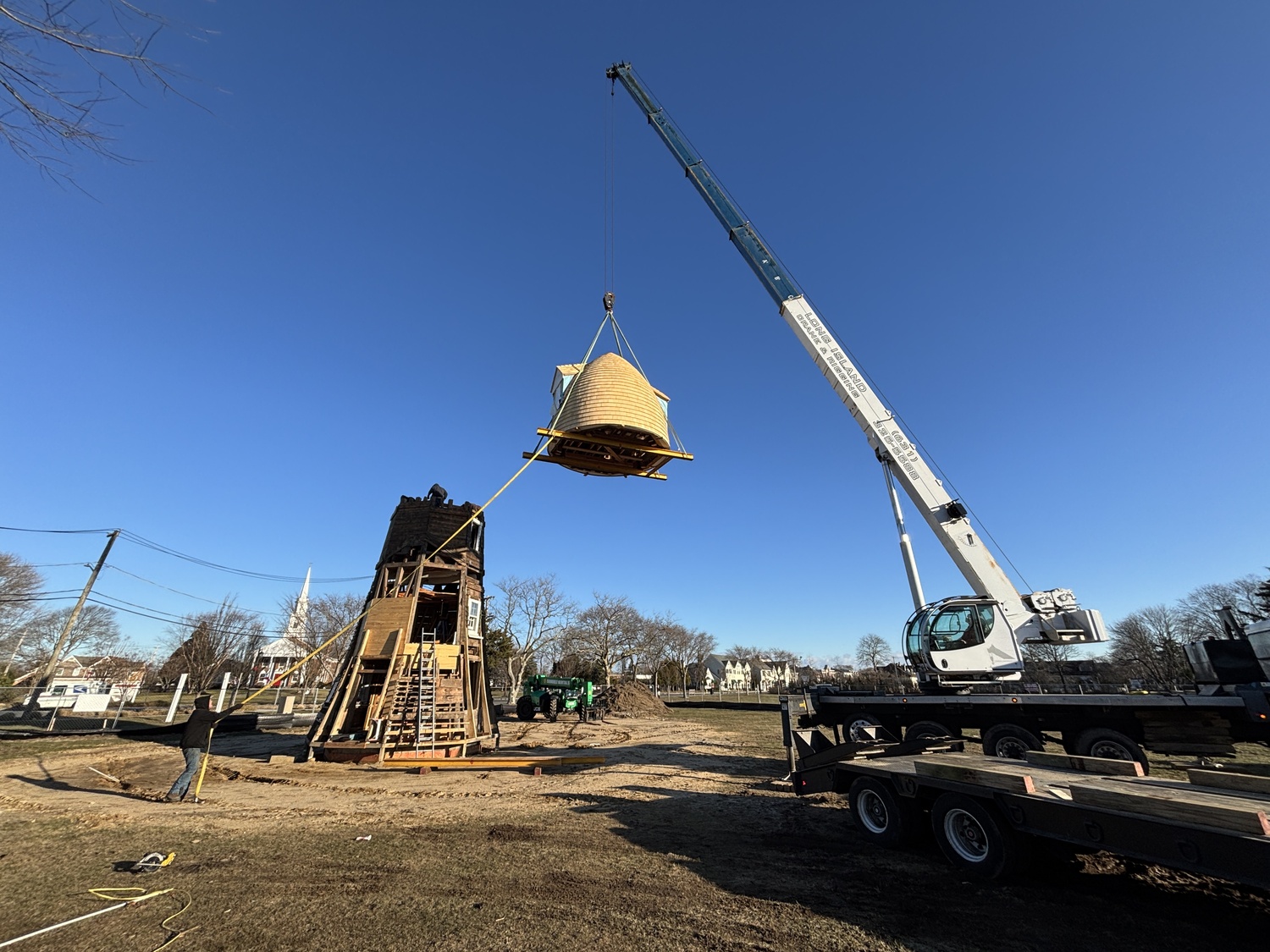 The top two portions of the Dix Windmill were placed on top of the windmill last Thursday, January 2, on the Great Lawn in Westhampton Beach. COURTESY MATT JEDLICKA, LKMA