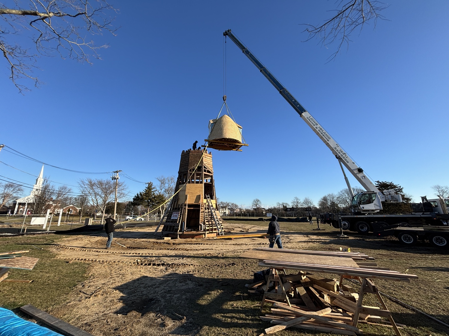 The top two portions of the Dix Windmill were placed on top of the windmill last Thursday, January 2, on the Great Lawn in Westhampton Beach. COURTESY MATT JEDLICKA, LKMA