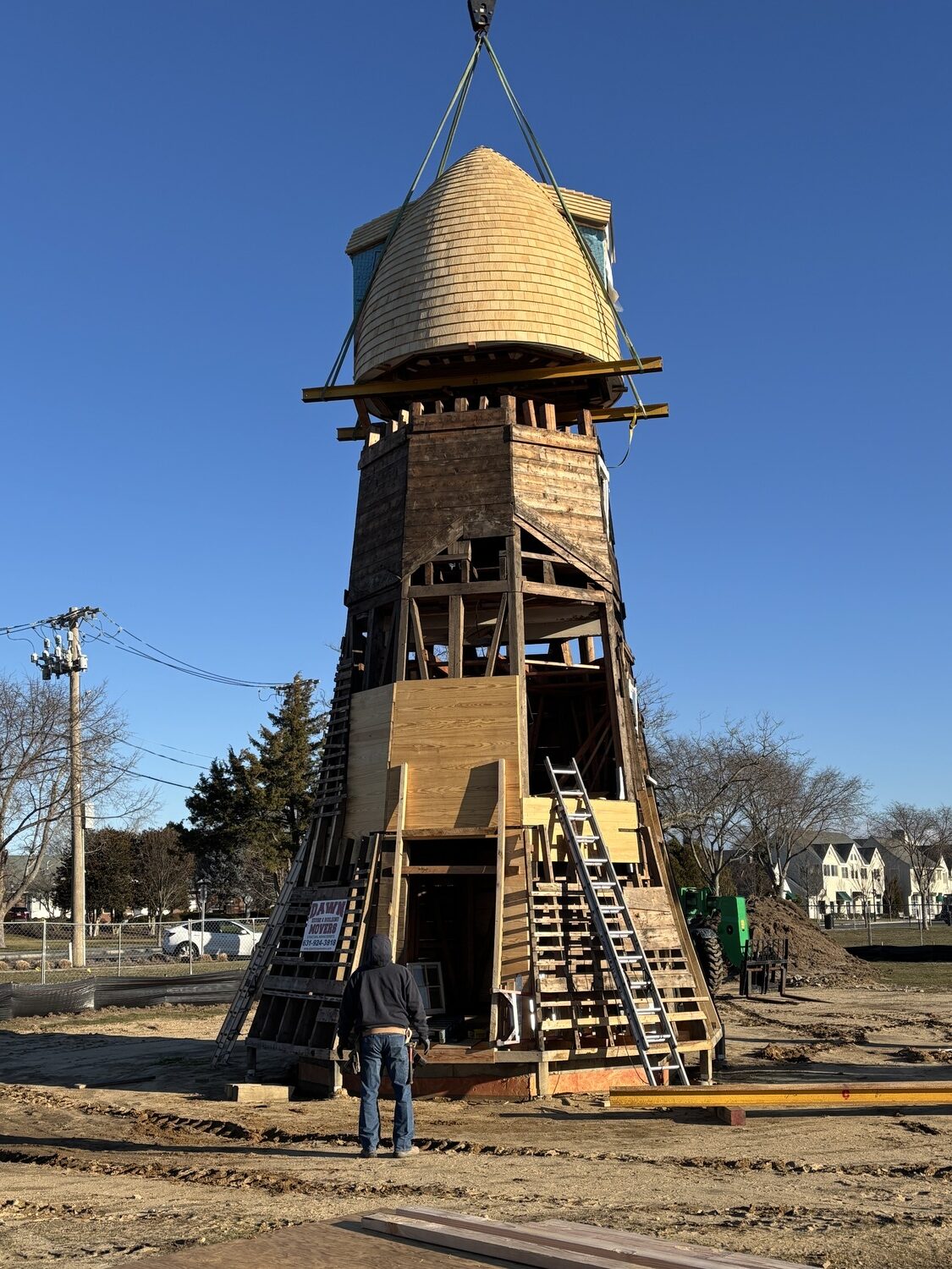 The top two portions of the Dix Windmill were placed on top of the windmill last Thursday, January 2, on the Great Lawn in Westhampton Beach. COURTESY MATT JEDLICKA, LKMA