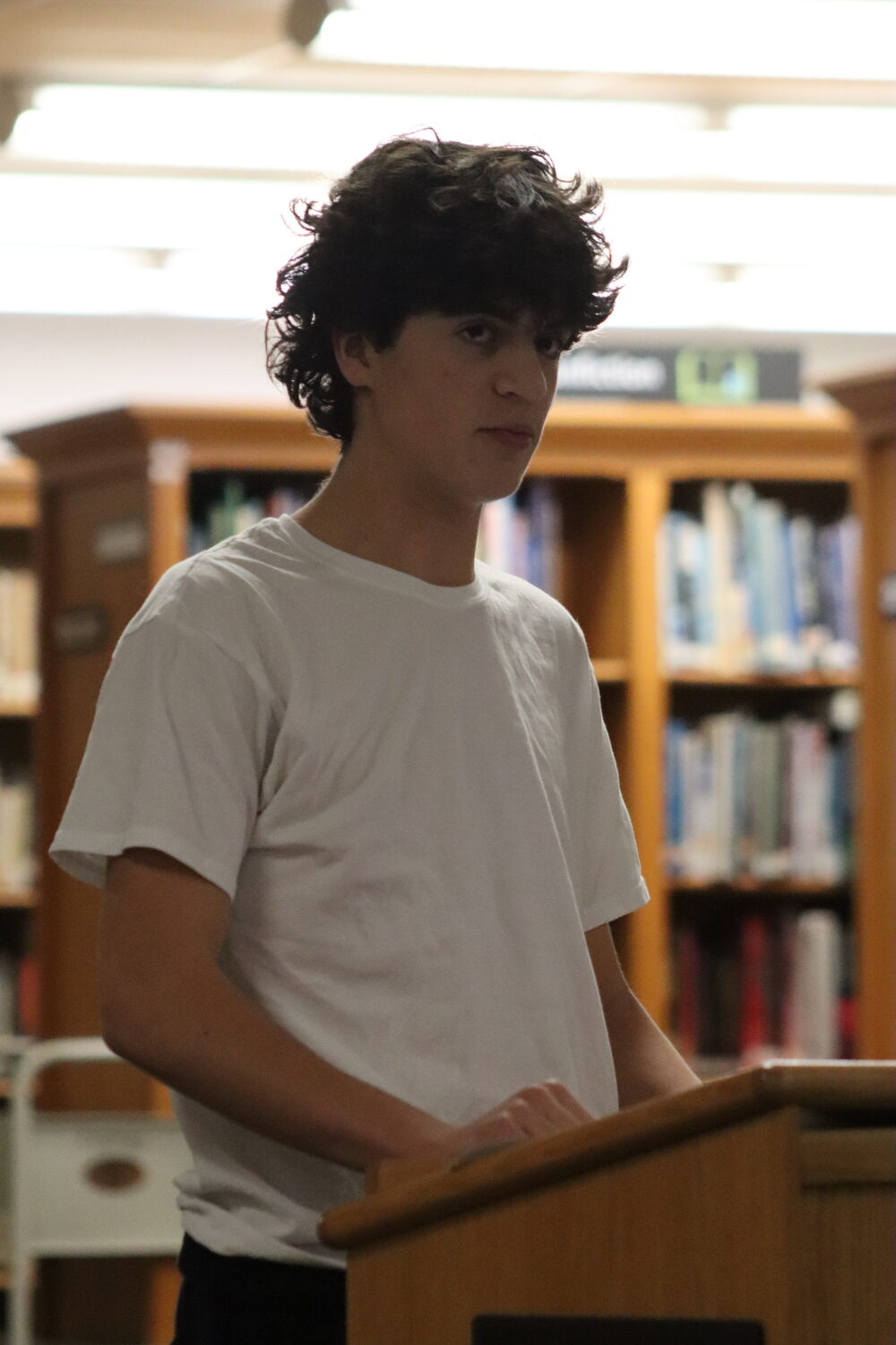 Maxwell Vogel, a sophomore and member of the Pierson varsity boys basketball team, speaks during public comment. CAILIN RILEY