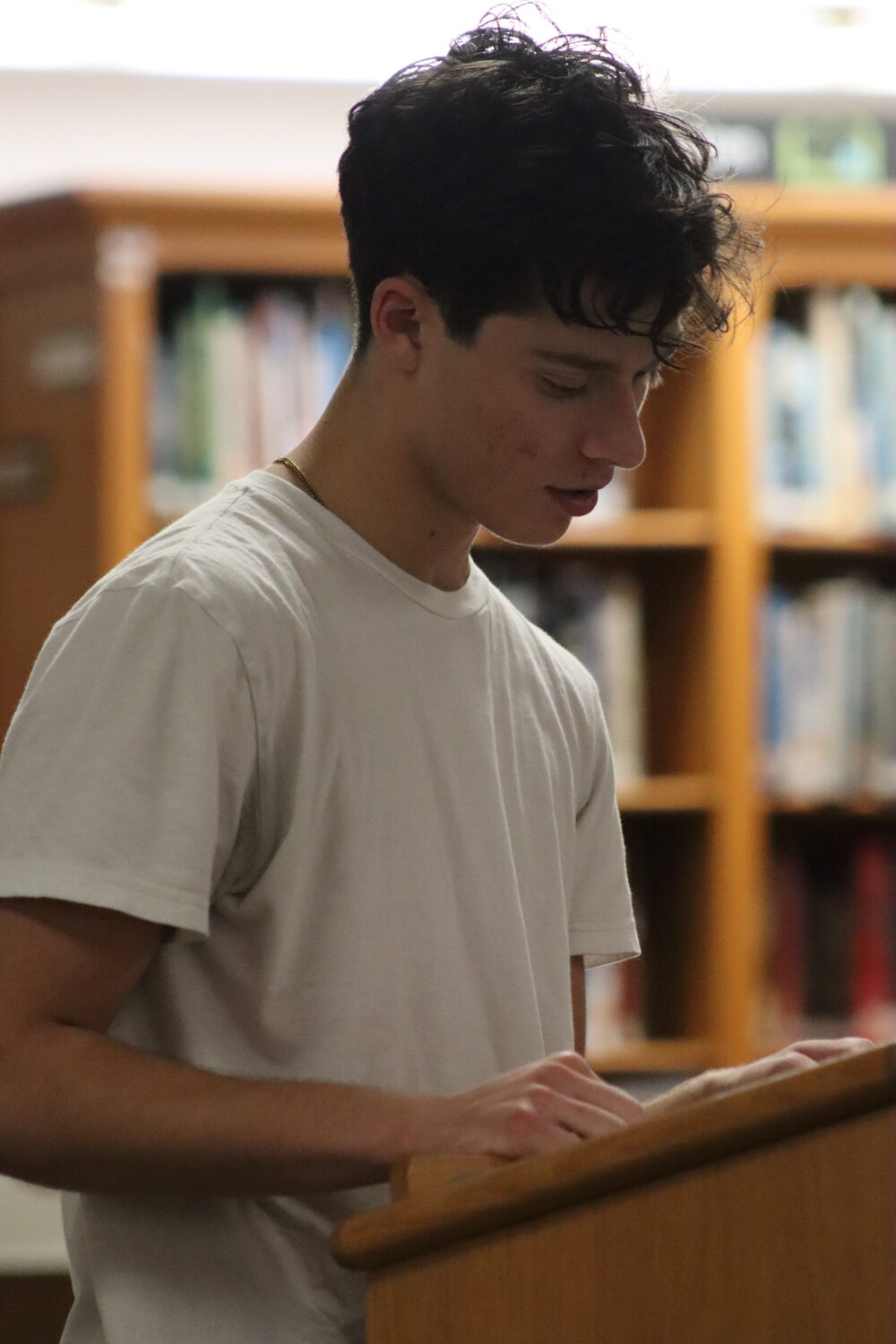 Casey Finelli, a sophomore and member of the Pierson boys basketball team, speaks during public comment. CAILIN RILEY