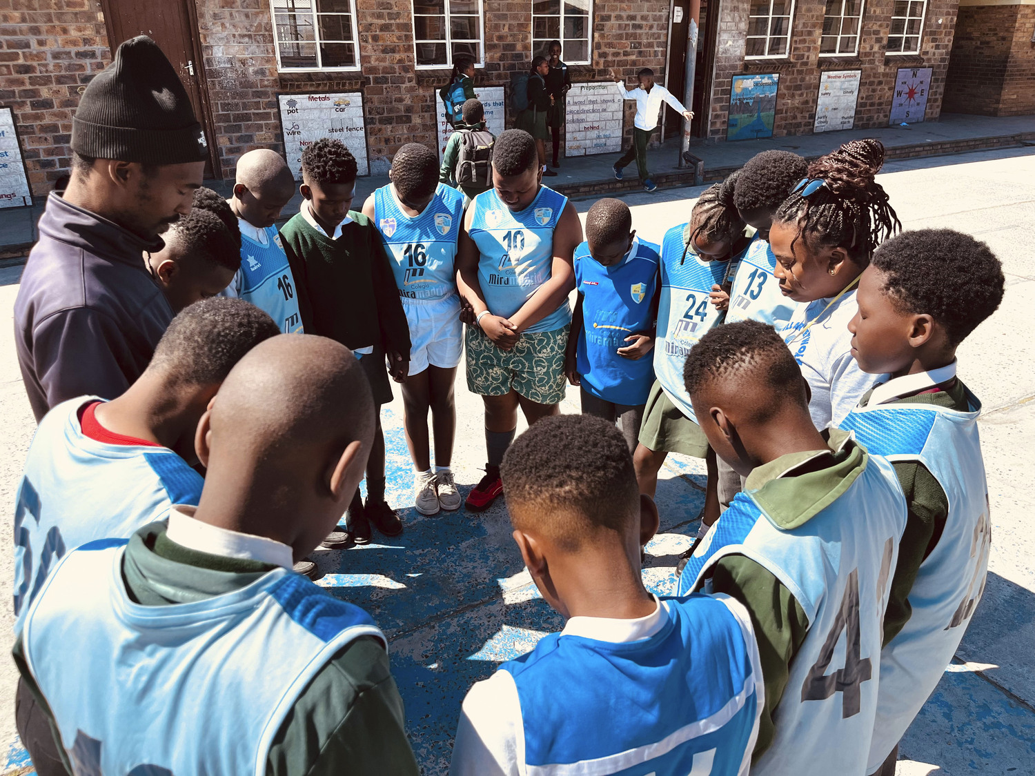 Students in South Africa bow their heads as part of a mediating moment. COURTESY ANTHONY ALLISON