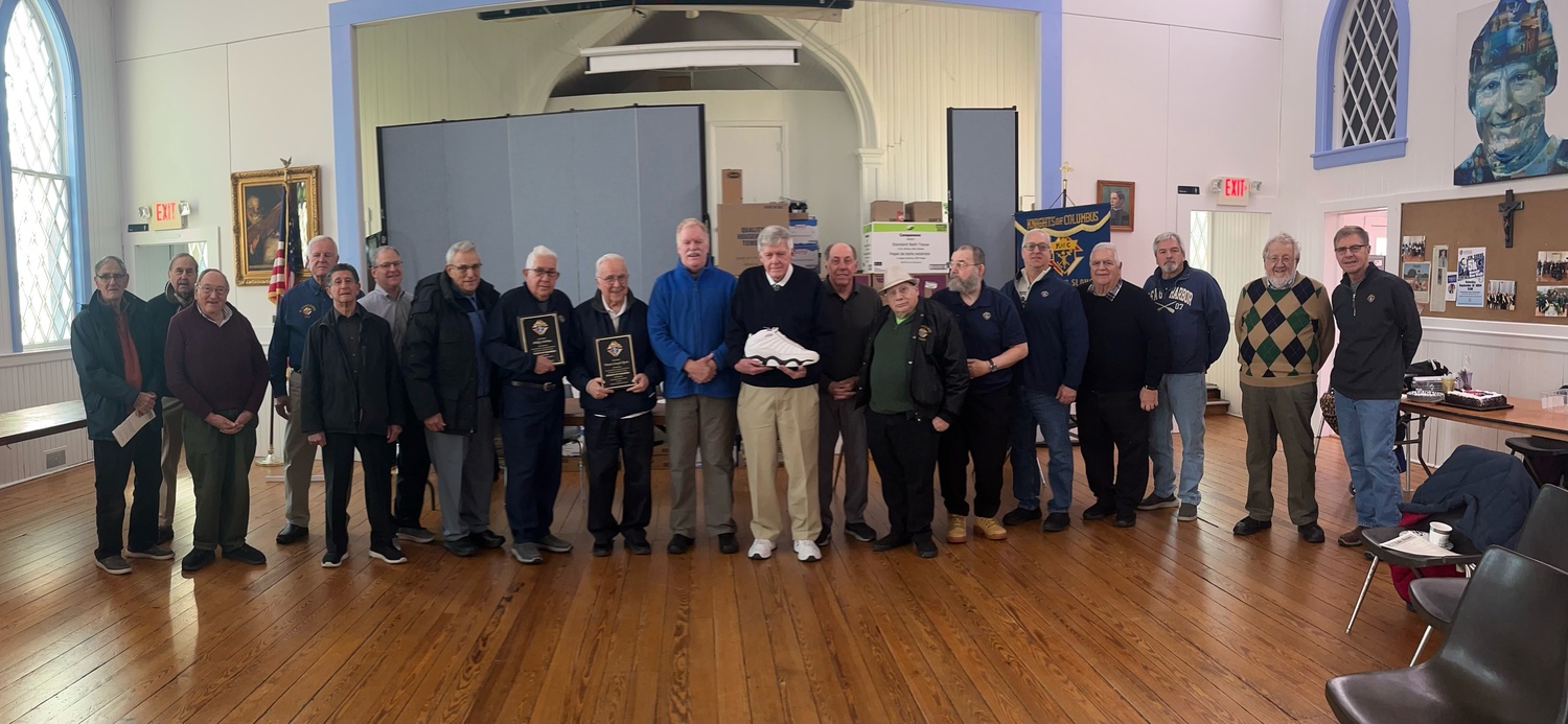 Members of the Father Slomski Council of the Knights of Columbus honored two of their brother Knights, the two men hold their plaques, Phil DeBrita, left, celebrating 45 years of service,  and Deacon Joe Byrne, celebrating 50 years. COURTESY KNIGHTS OF COLUMBUS