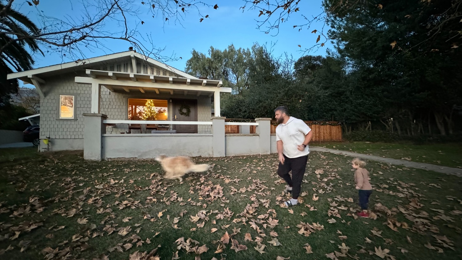 Alex Luppi and his son, Isaac, play fetch with their dog, Norman, outside their home in Altadena, California — before the Eaton Fire earlier this month reduced it to ash and rubble. COURTESY BEN LUPPI/GOFUNDME