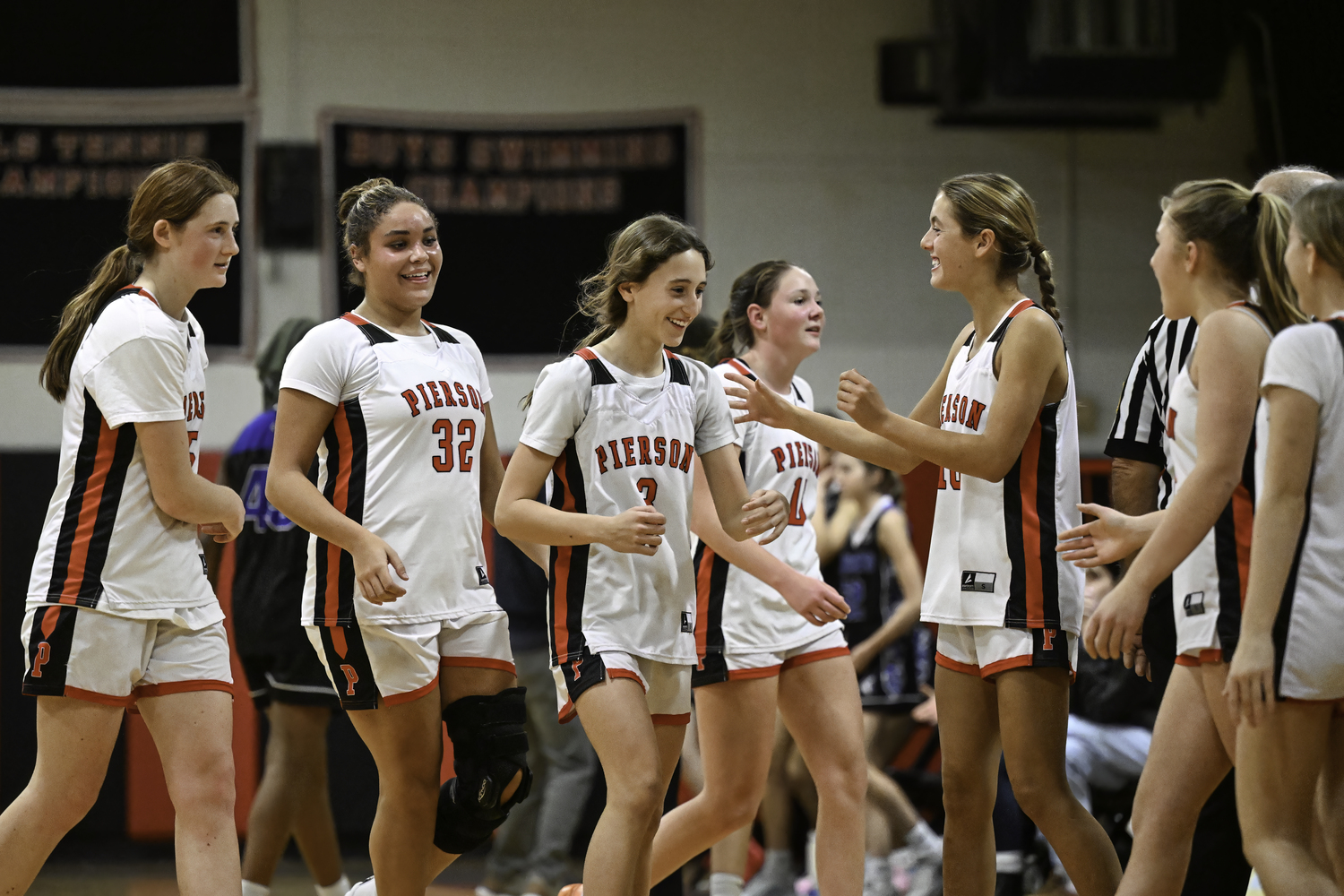 The Whalers congratulated Molly Wolfson after she made all three free throws late in the game.  MARIANNE BARNETT