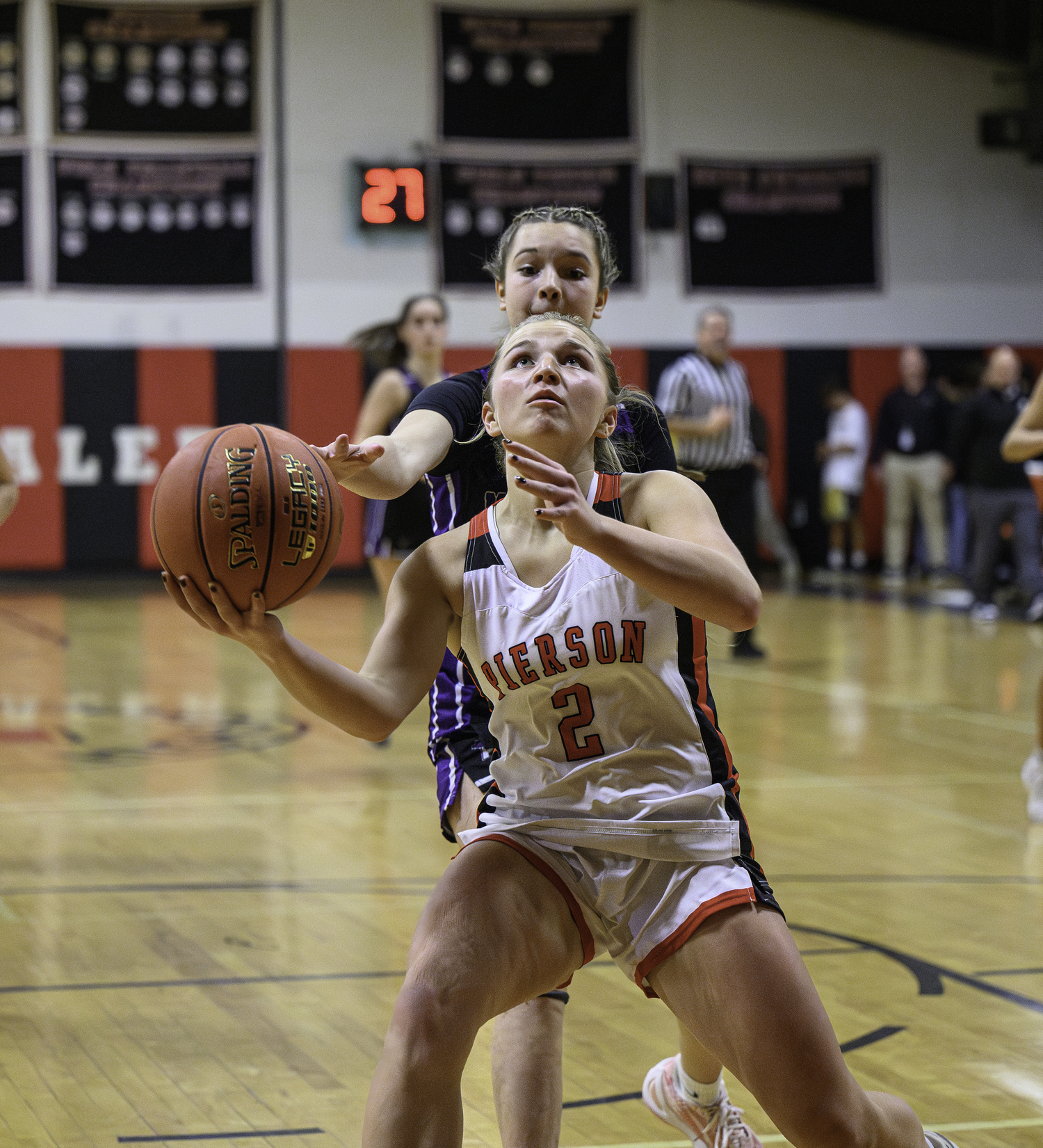 Abby Perello is fouled by a trailing Port Jefferson player while going up for a shot.   MARIANNE BARNETT